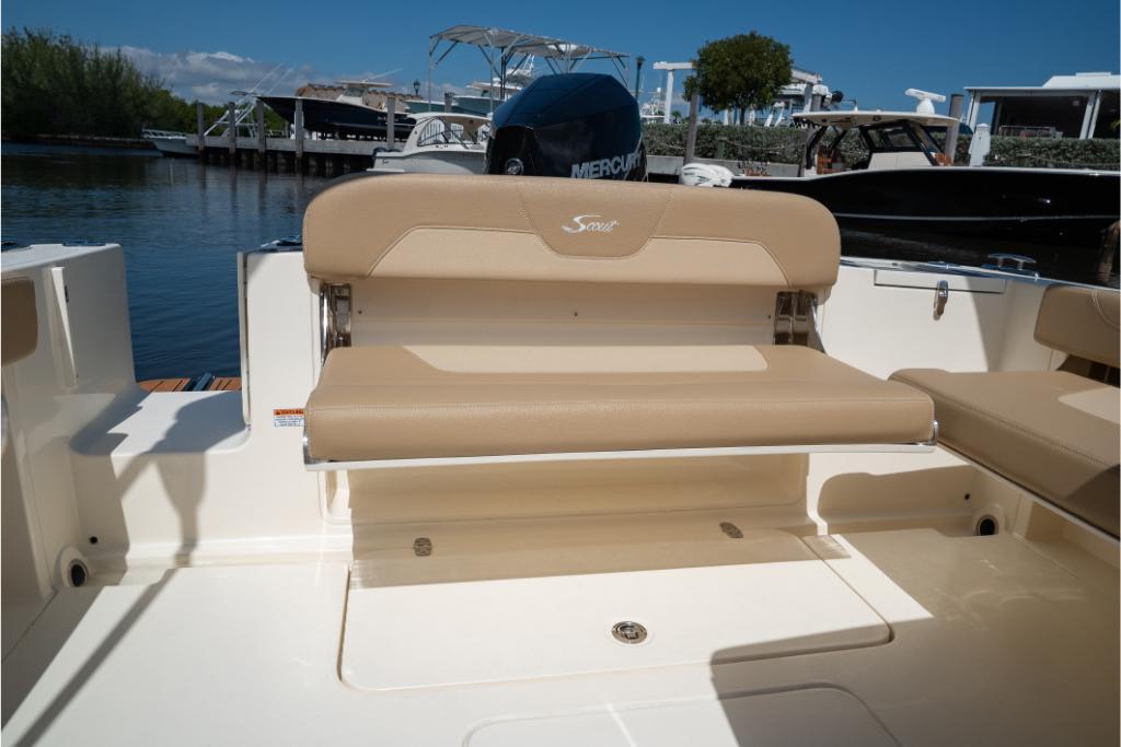 2023 Scout 240 Dorado boat with tan seating, docked by the water.