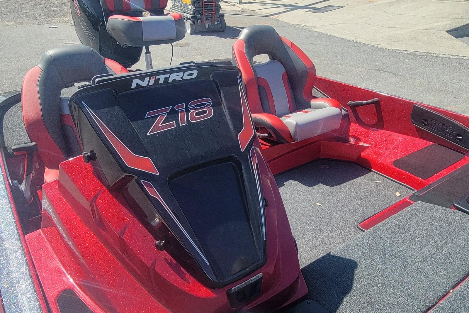 2026 Nitro Z18 boat interior with red and gray seating, showcasing sleek design.