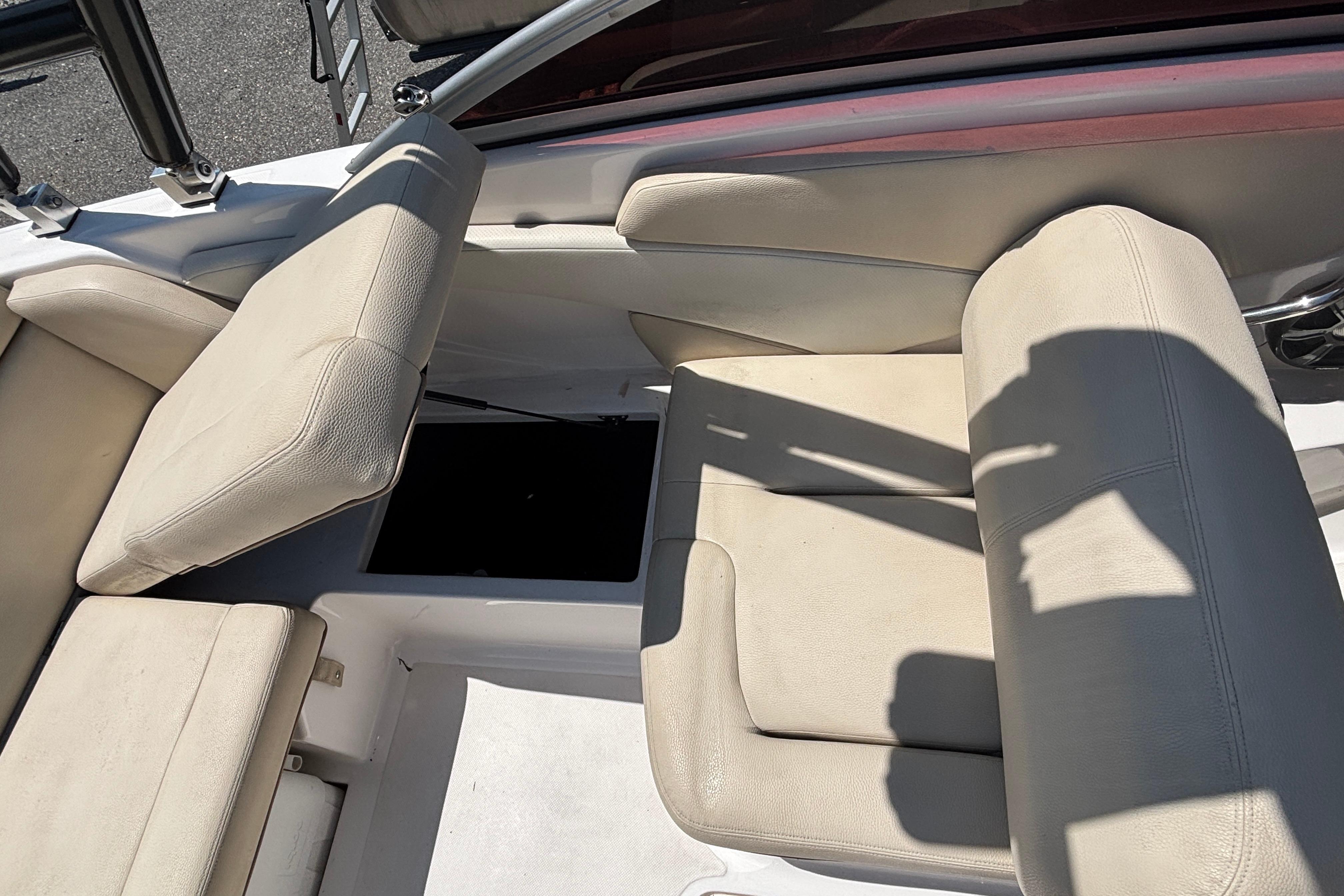 2018 Regal 1900 ES Bowrider interior seating with storage compartment open.