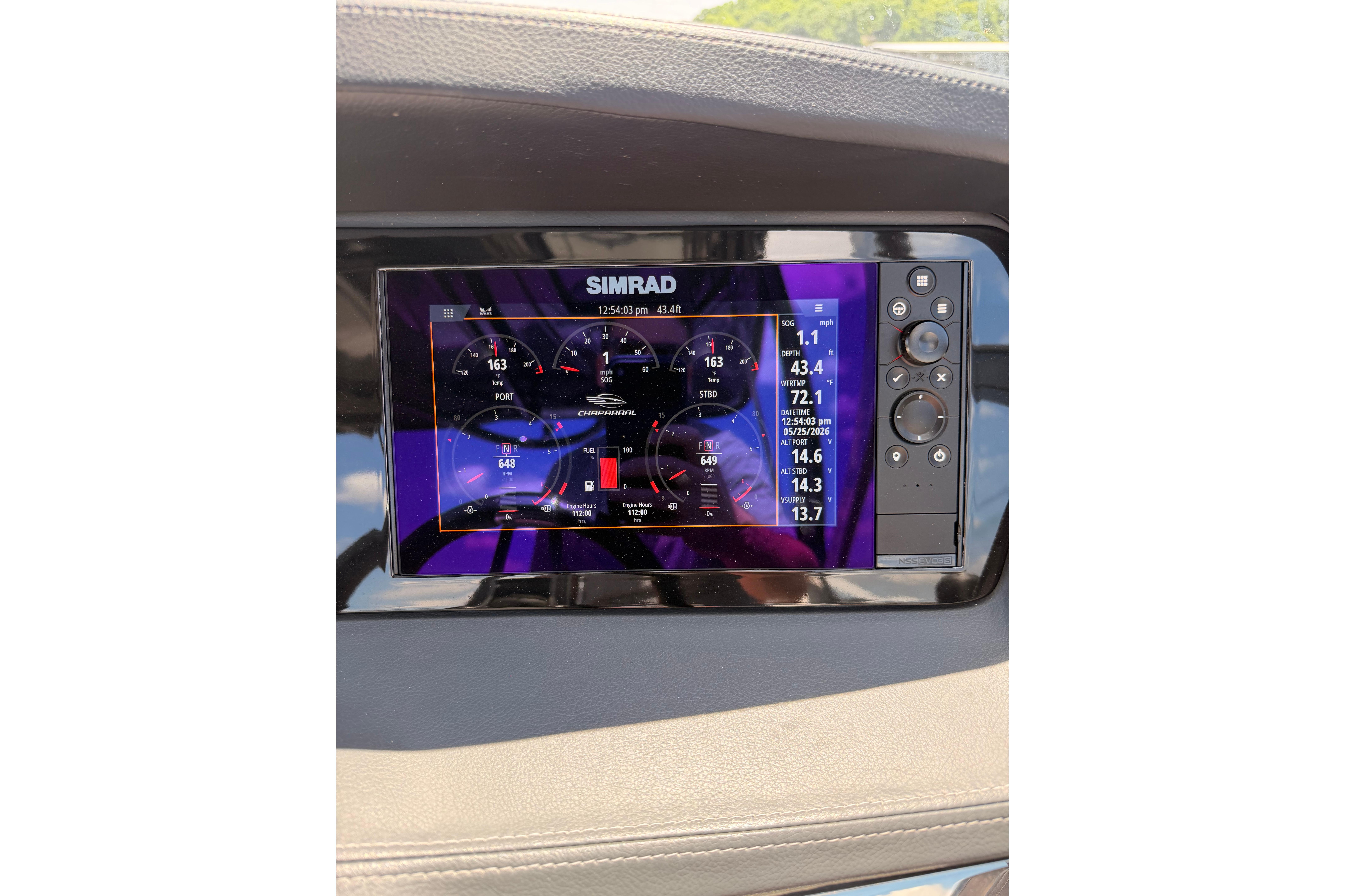 Simrad display on 2022 Chaparral 317 SSX boat dashboard showing navigation and engine data.