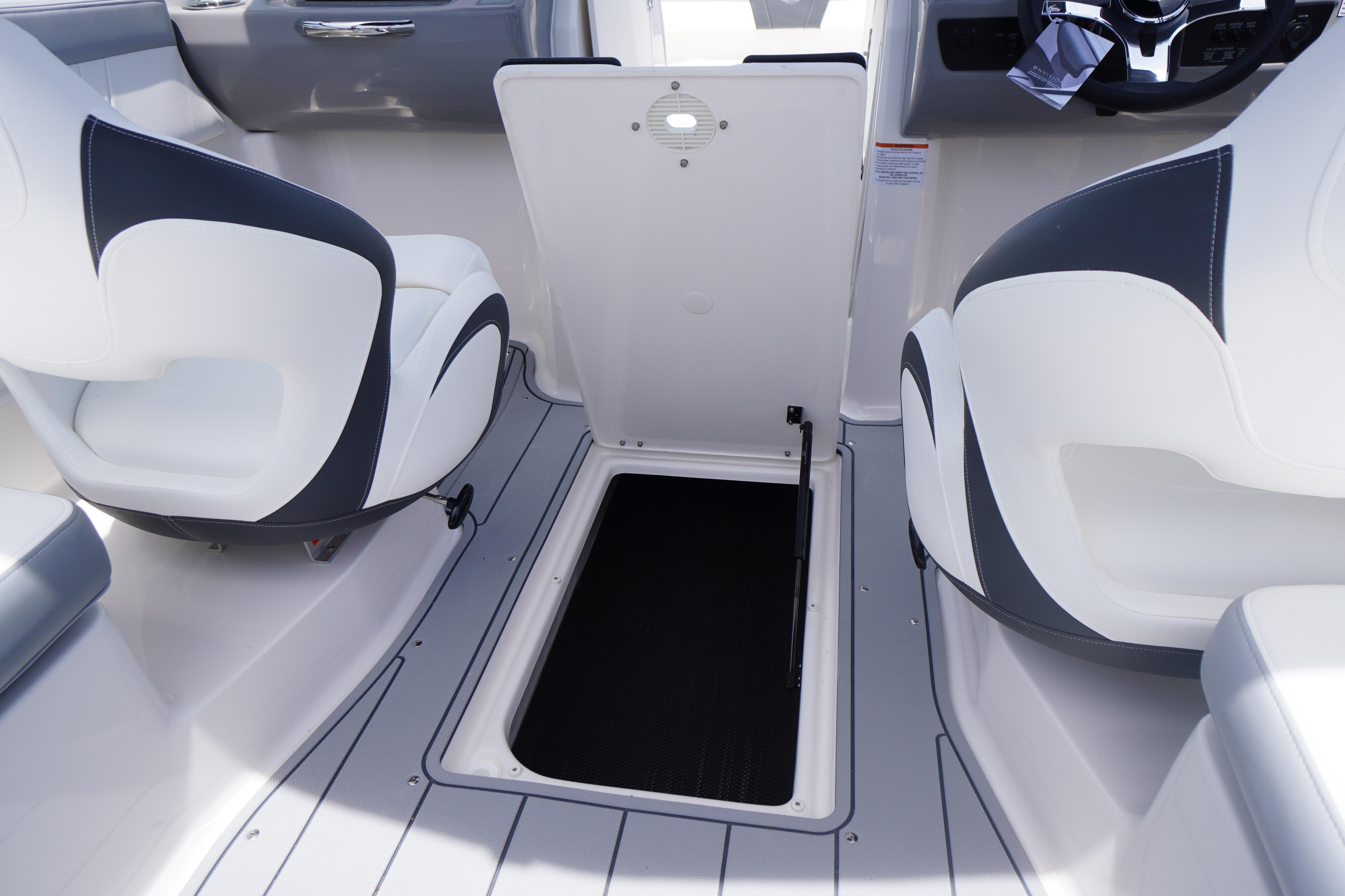 2026 Chaparral 23 SSi OB boat interior with open storage compartment.
