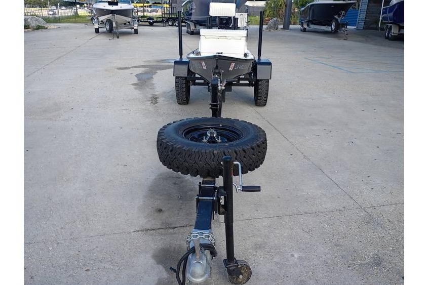 Trailer with Pelican Ambush boat, 2013 model, parked on concrete surface.