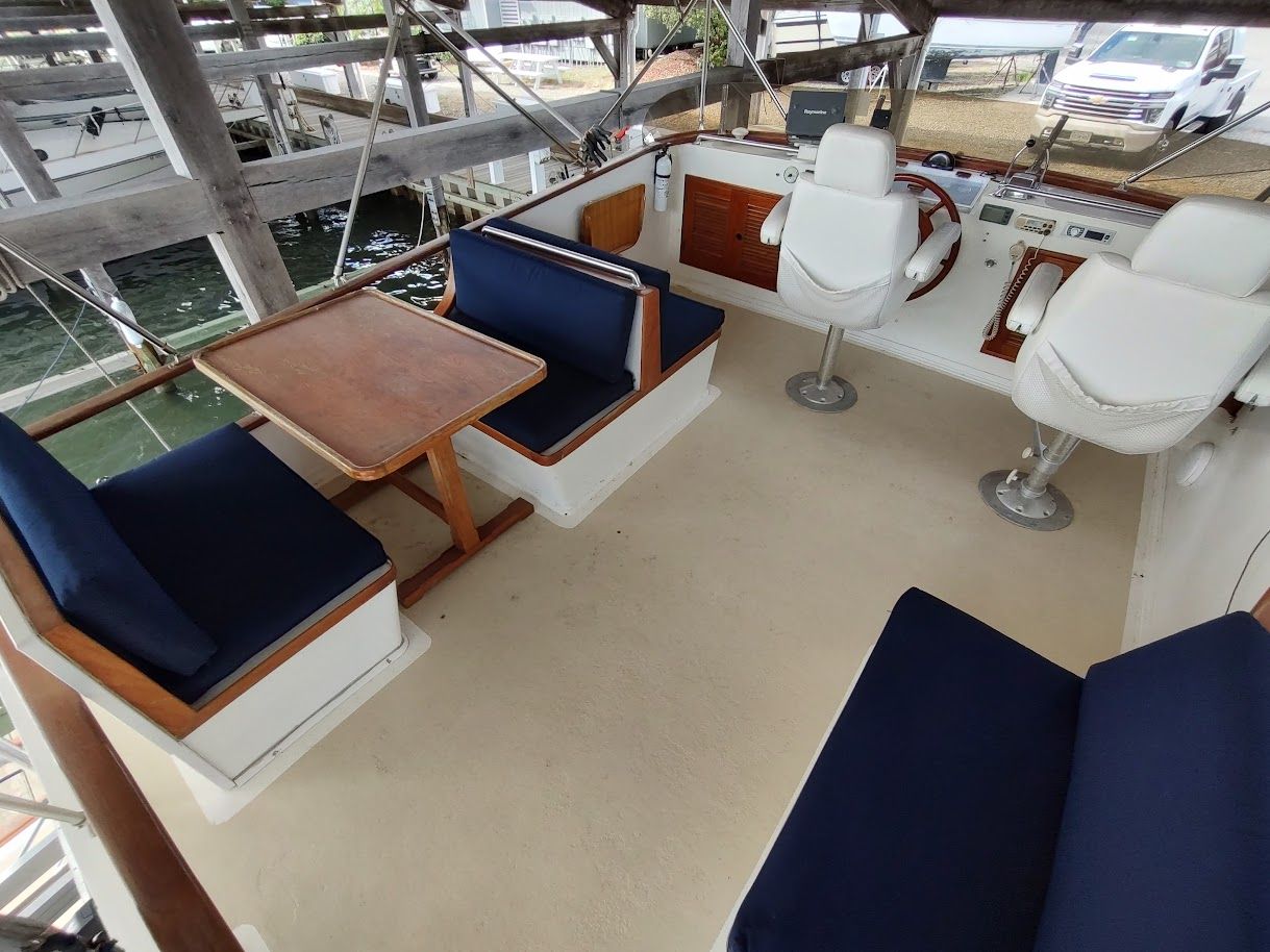 Marine Trader Double Cabin 40, 1983, interior with blue seating and table.