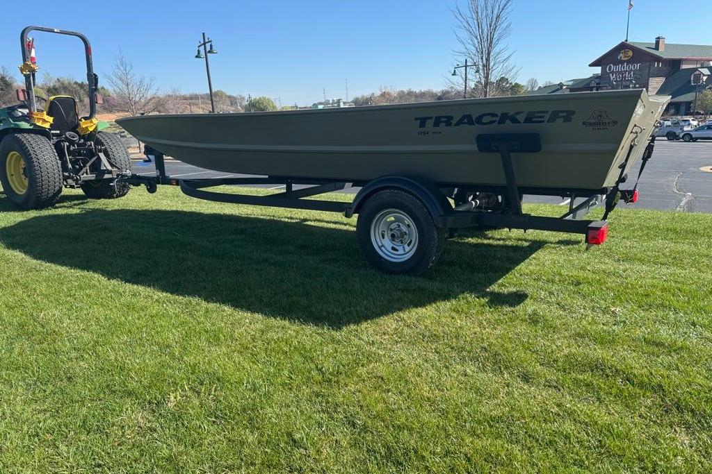2026 Tracker Grizzly 1754 Utility boat on trailer, parked on grass, sunny day.
