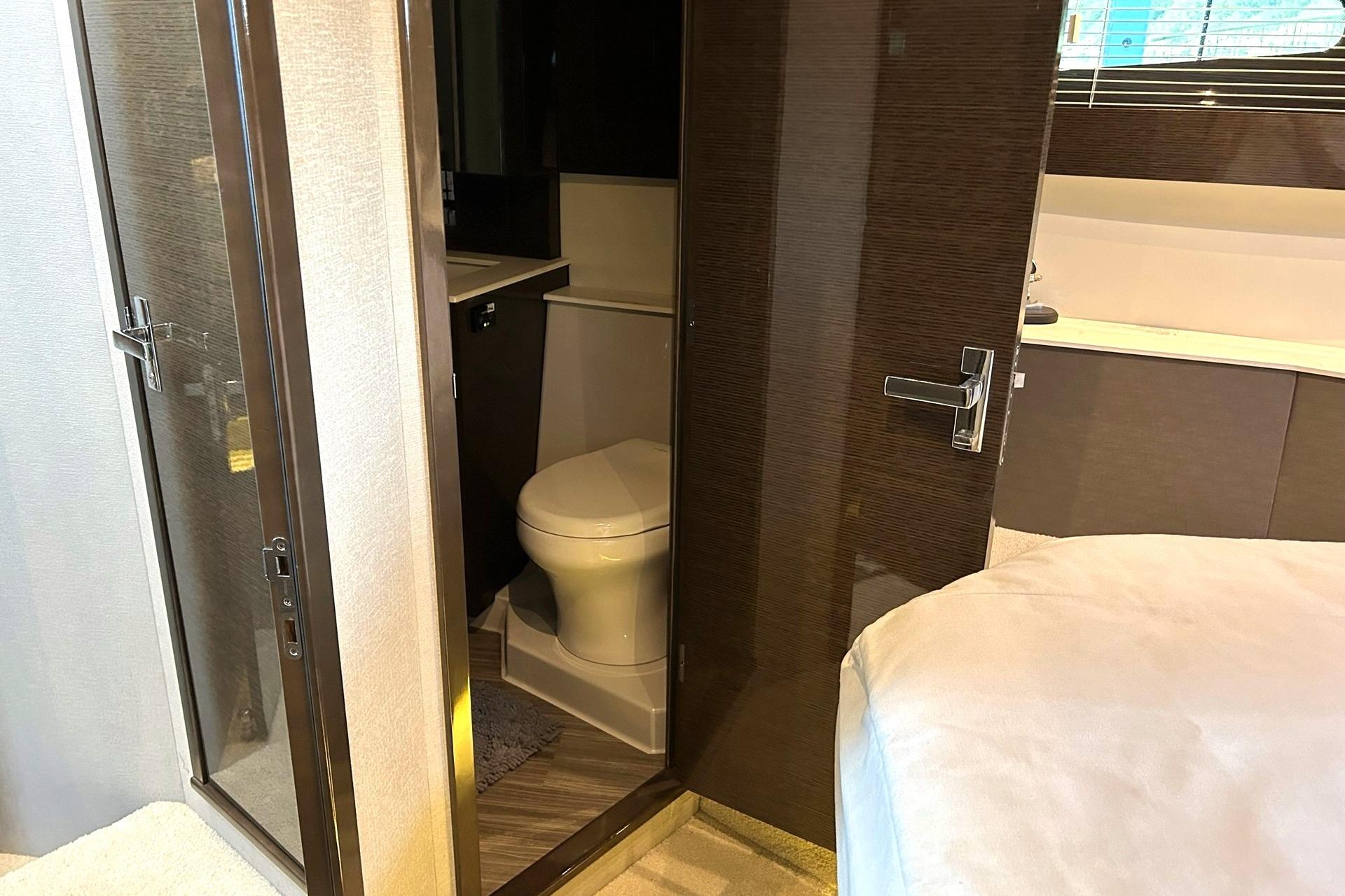 Luxurious bathroom interior of 2021 Cruisers Yachts 50 Cantius with modern fixtures.