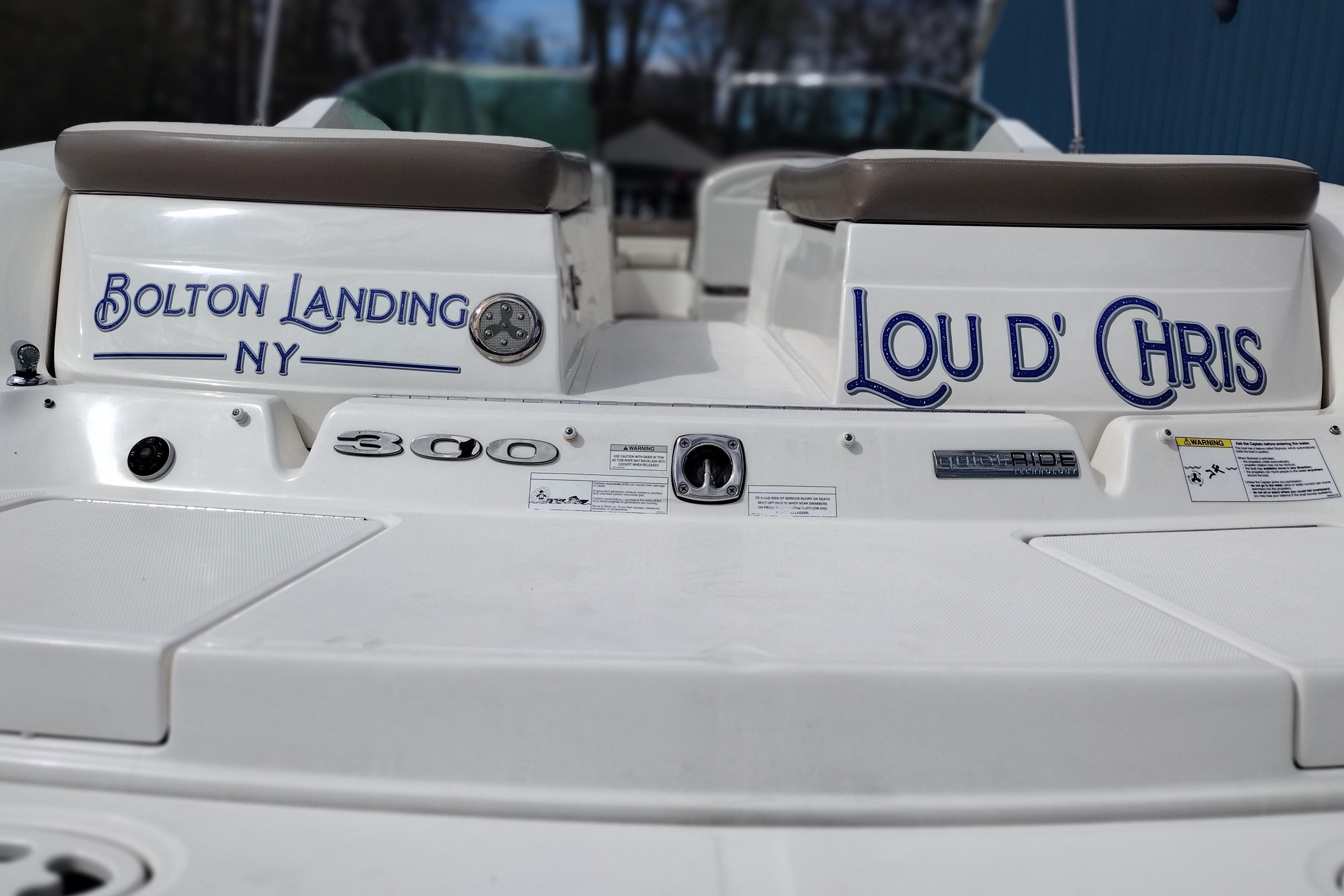 2013 Sea Ray 300 SLX boat with "Bolton Landing NY" and "Lou D' Chris" text.