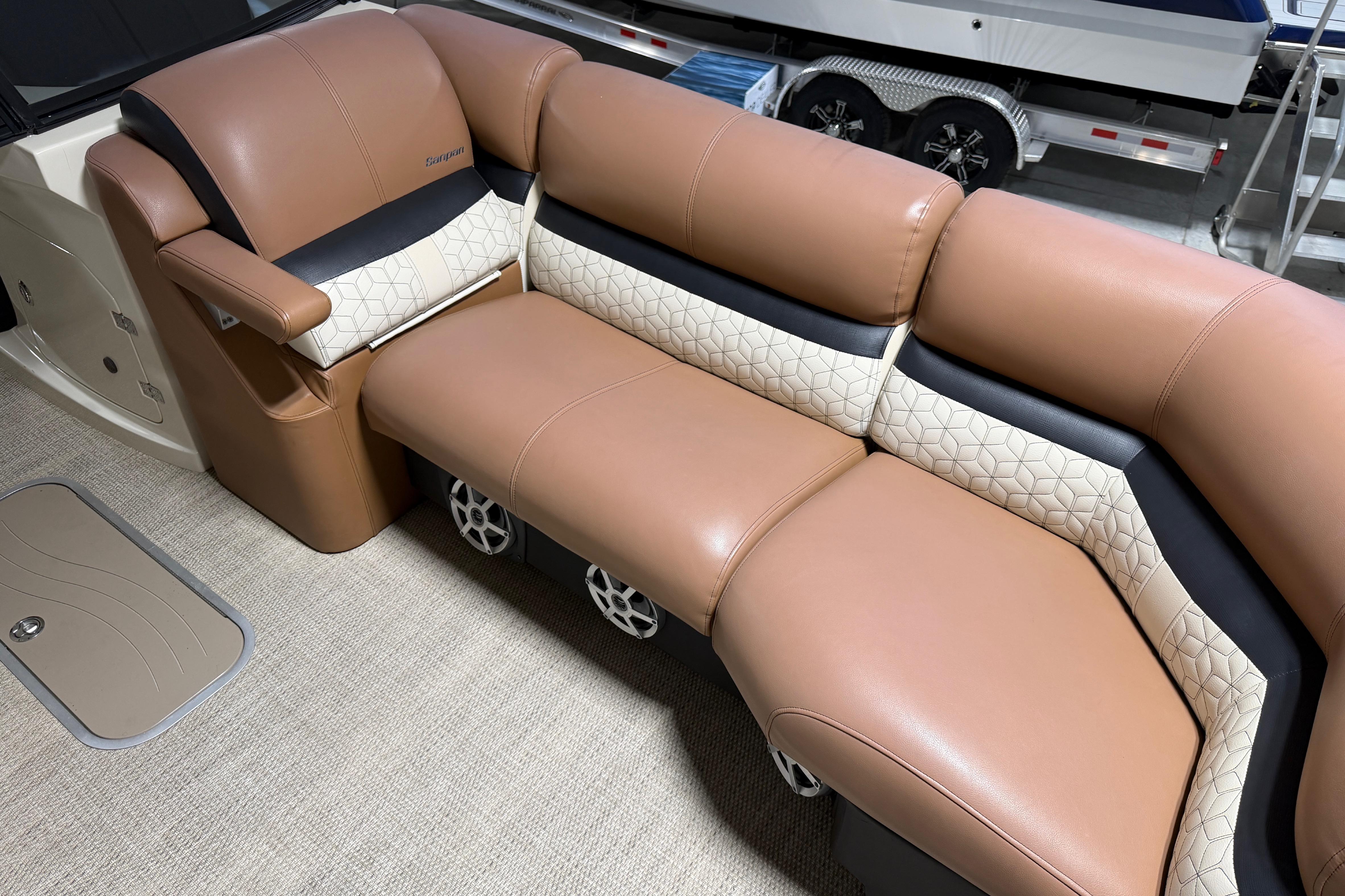 Luxurious seating on 2018 Godfrey Sanpan 2500 ULC pontoon boat, featuring tan and cream upholstery.