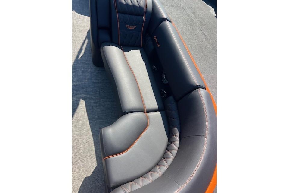 Luxurious seating on 2024 Bennington 23 RXFBA boat with sleek design and orange accents.