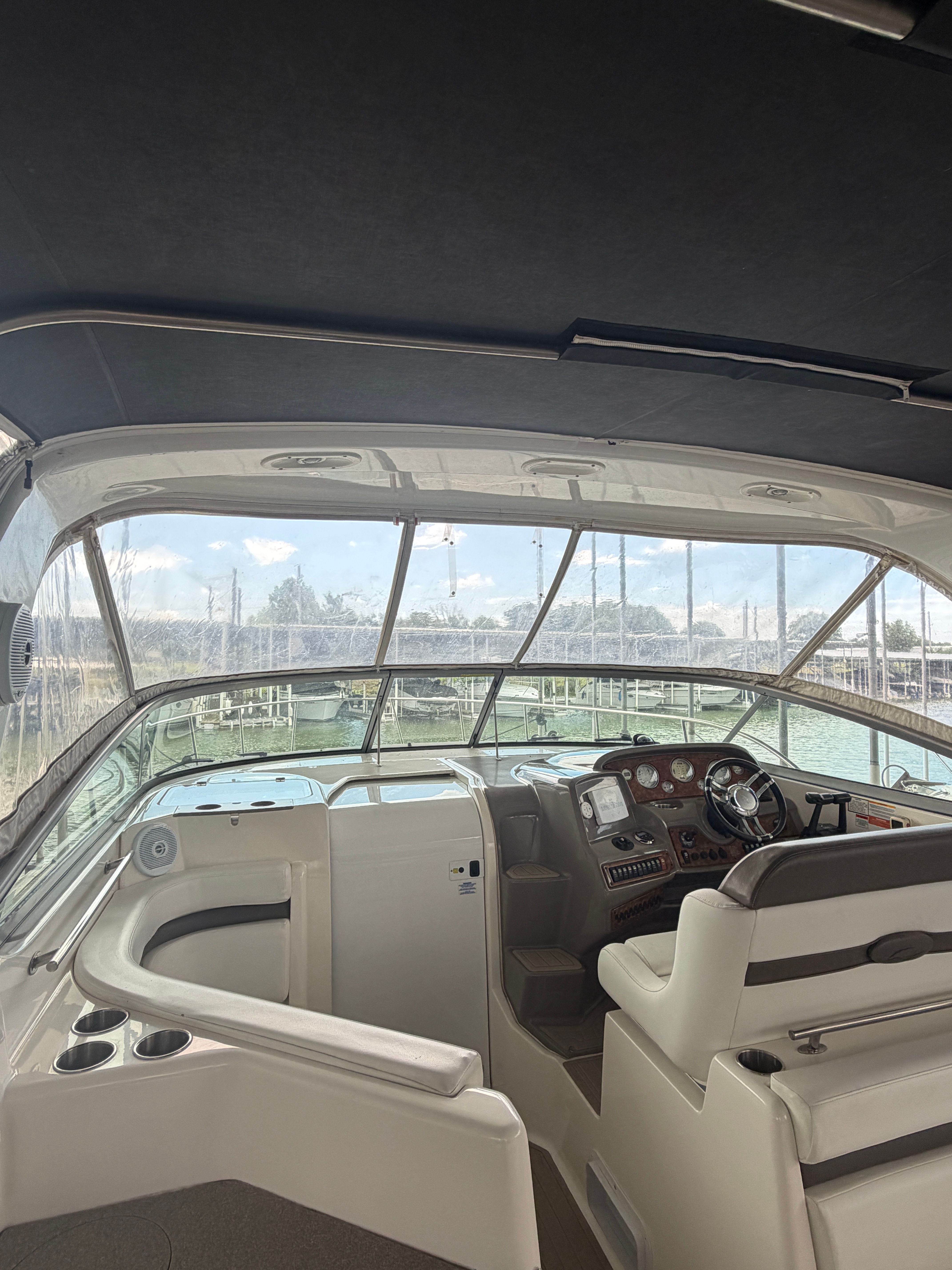 The image shows the cockpit of a 2007 Rinker 350 Express Cruiser with helm and seating area.