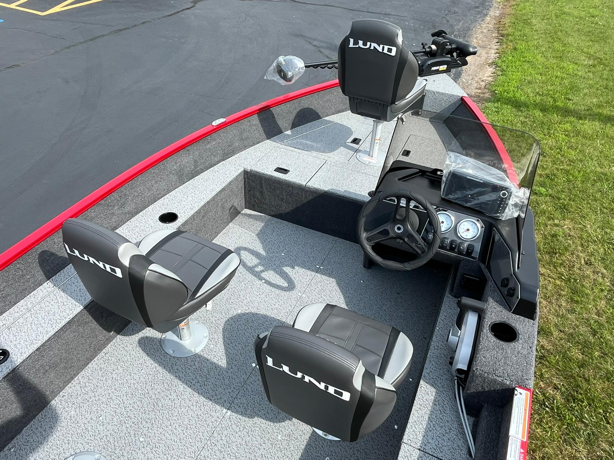 2026 Lund 1650 Angler SS boat interior with seats and steering console.