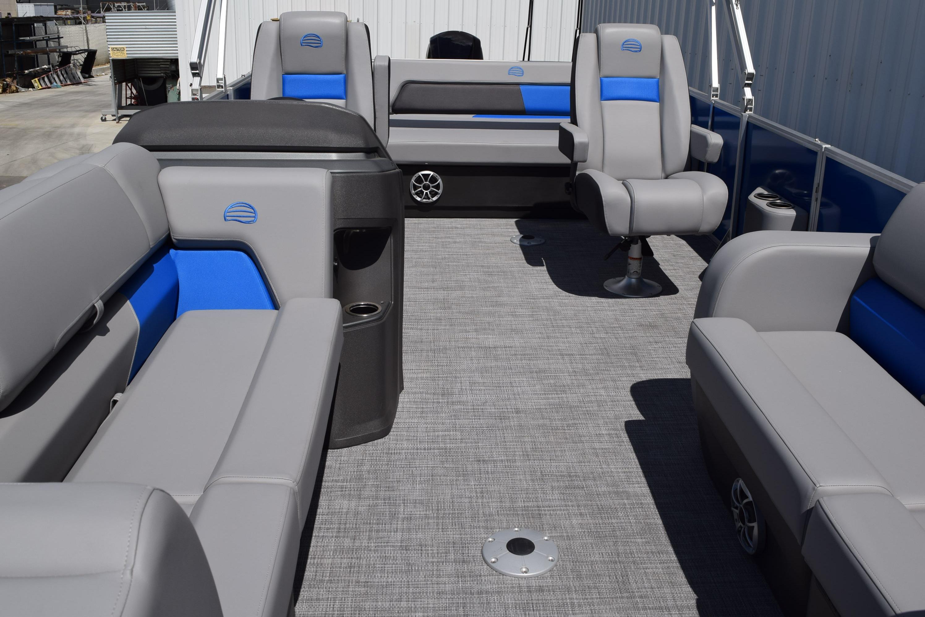 2026 Sun Tracker Party Barge 22 RF DLX interior with gray and blue seating.