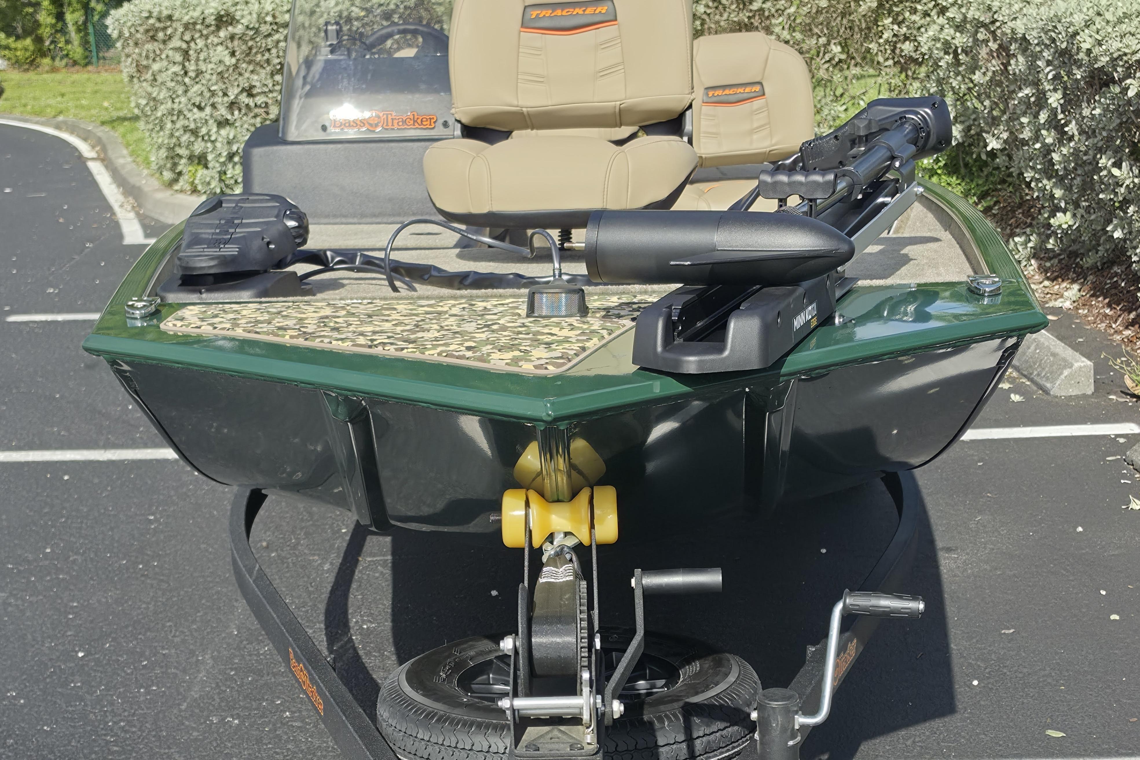 2026 Tracker Bass Tracker Classic Limited boat with trolling motor in parking lot.