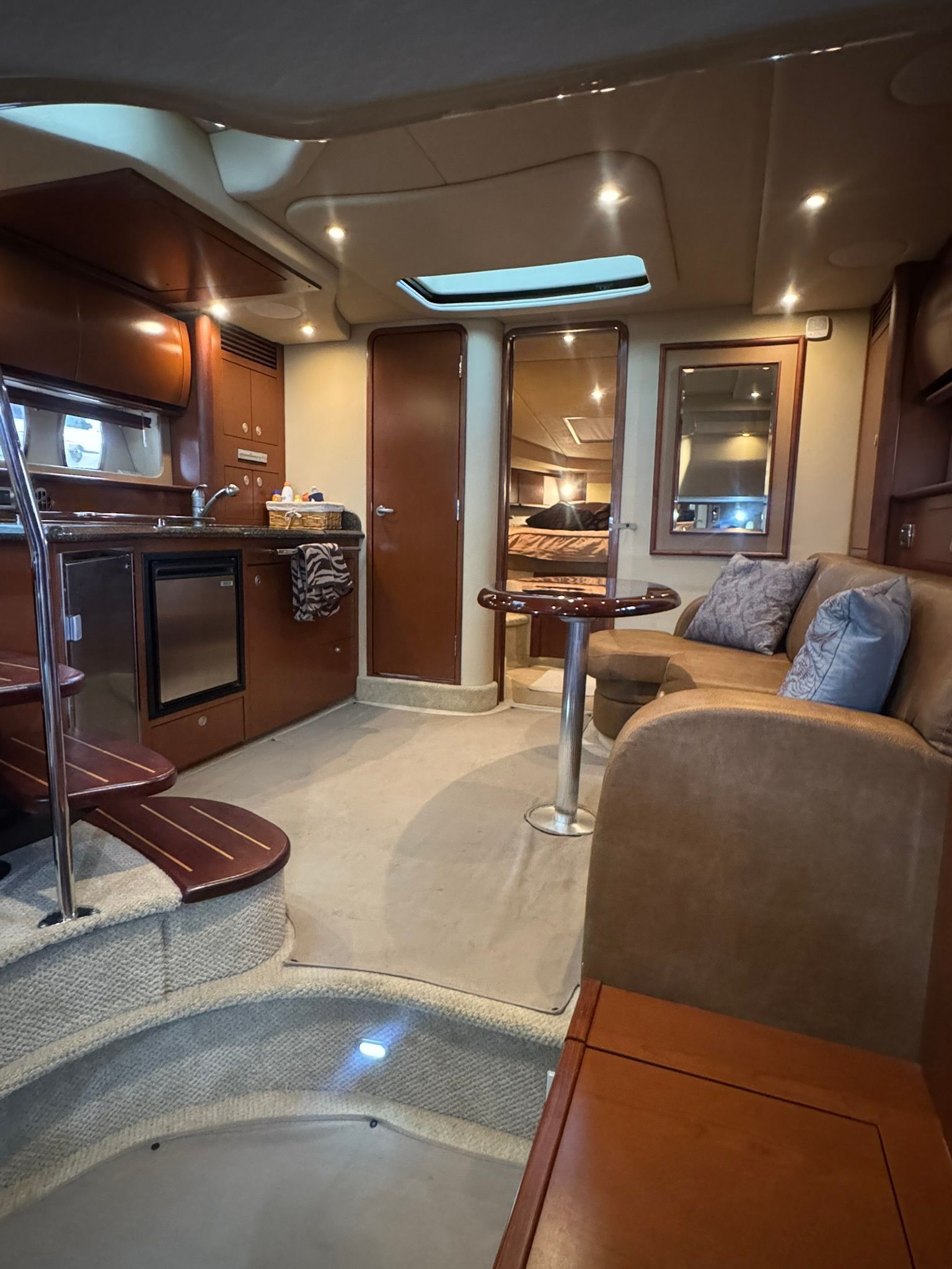 Interior of the 2007 Sea Ray 40 Sundancer with kitchen, sofa, and table.