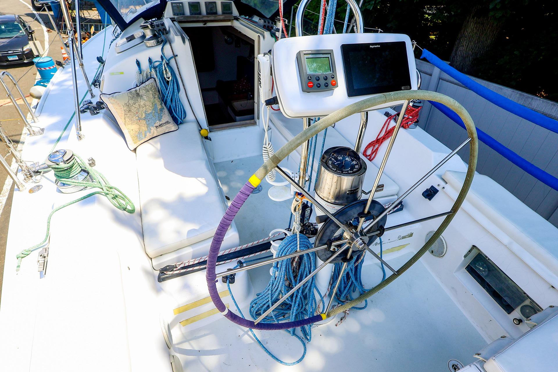 Cockpit of 2001 J Boats J/32 sailboat with steering wheel and navigation equipment.