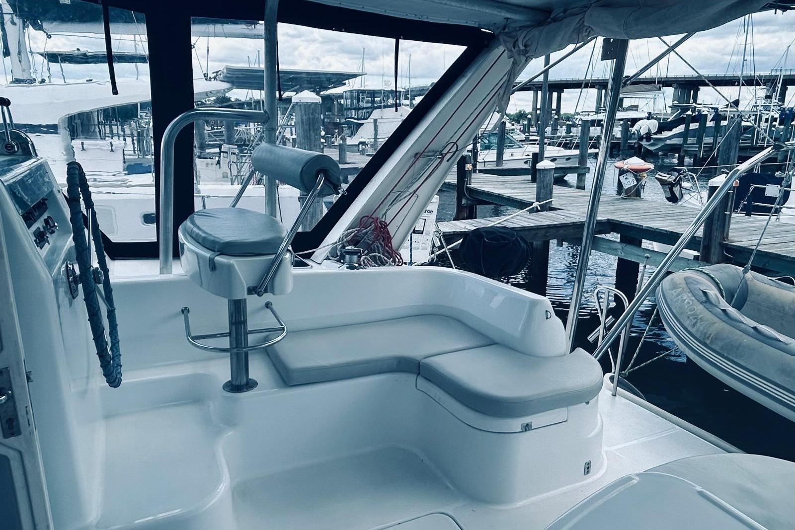 Cockpit of a 2001 Robertson & Caine Leopard yacht at a marina.