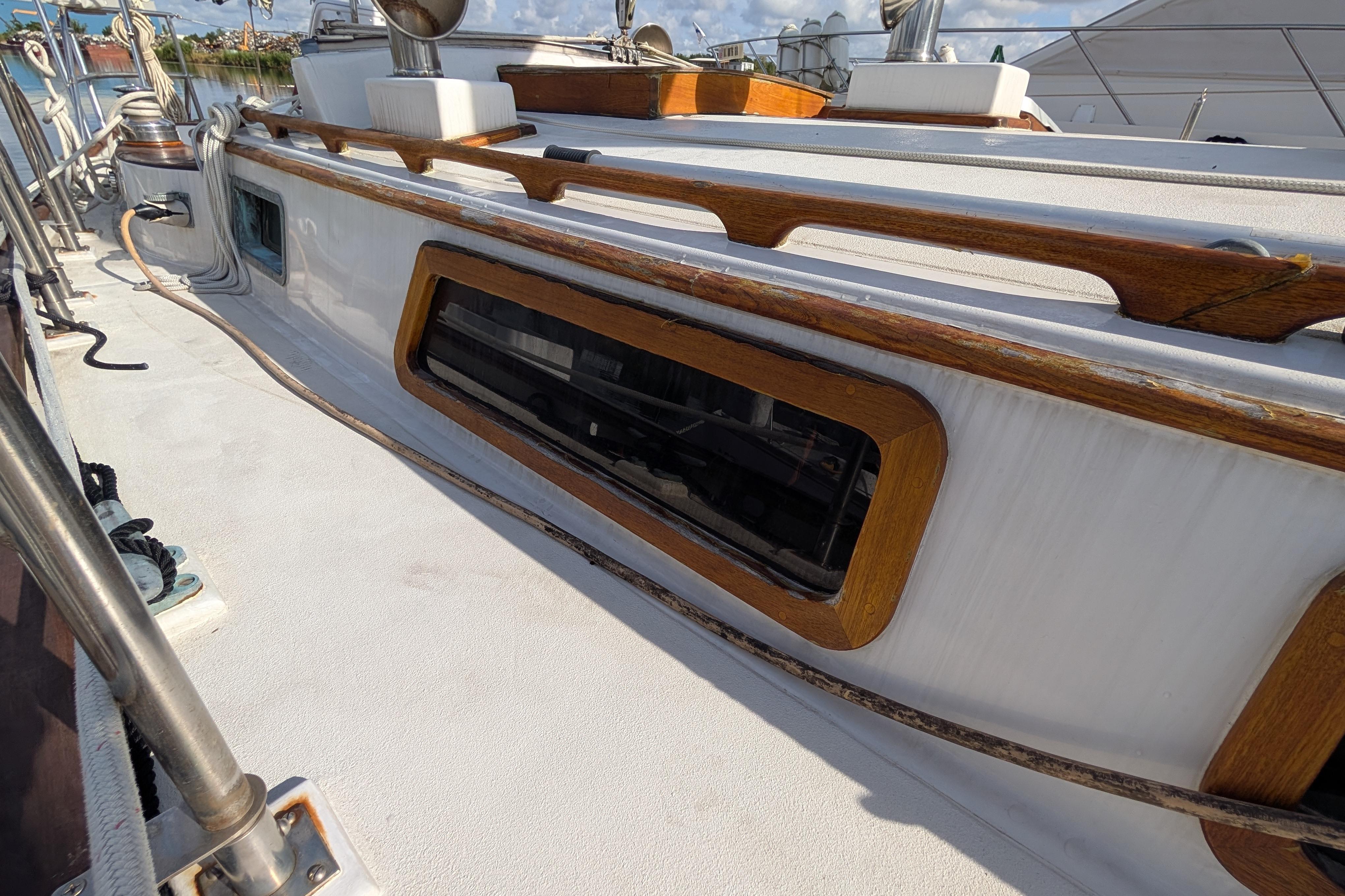 1983 Robert Perry 41 sailboat deck with wooden trim and window detail.