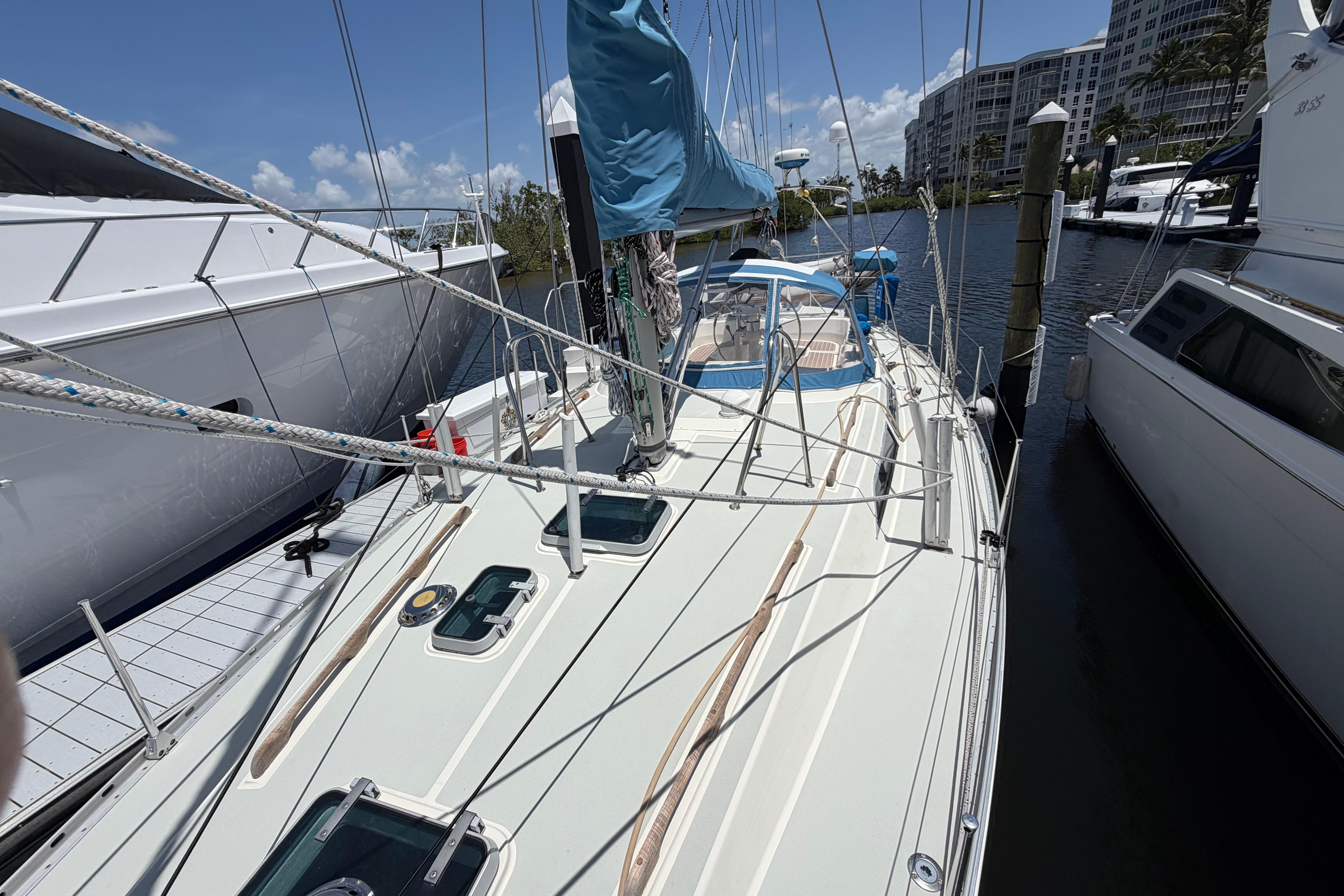 Sailboat Moody 376, 1987 model, docked at marina with clear skies.