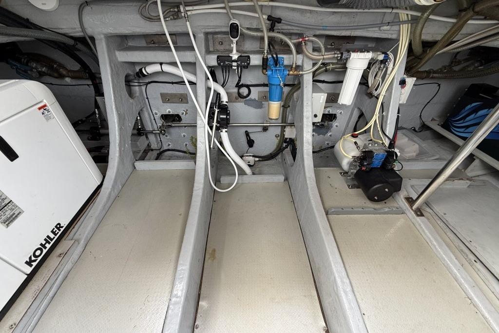 Engine room of 2012 Sasga Yachts Menorquin 42 with Kohler generator and plumbing systems.