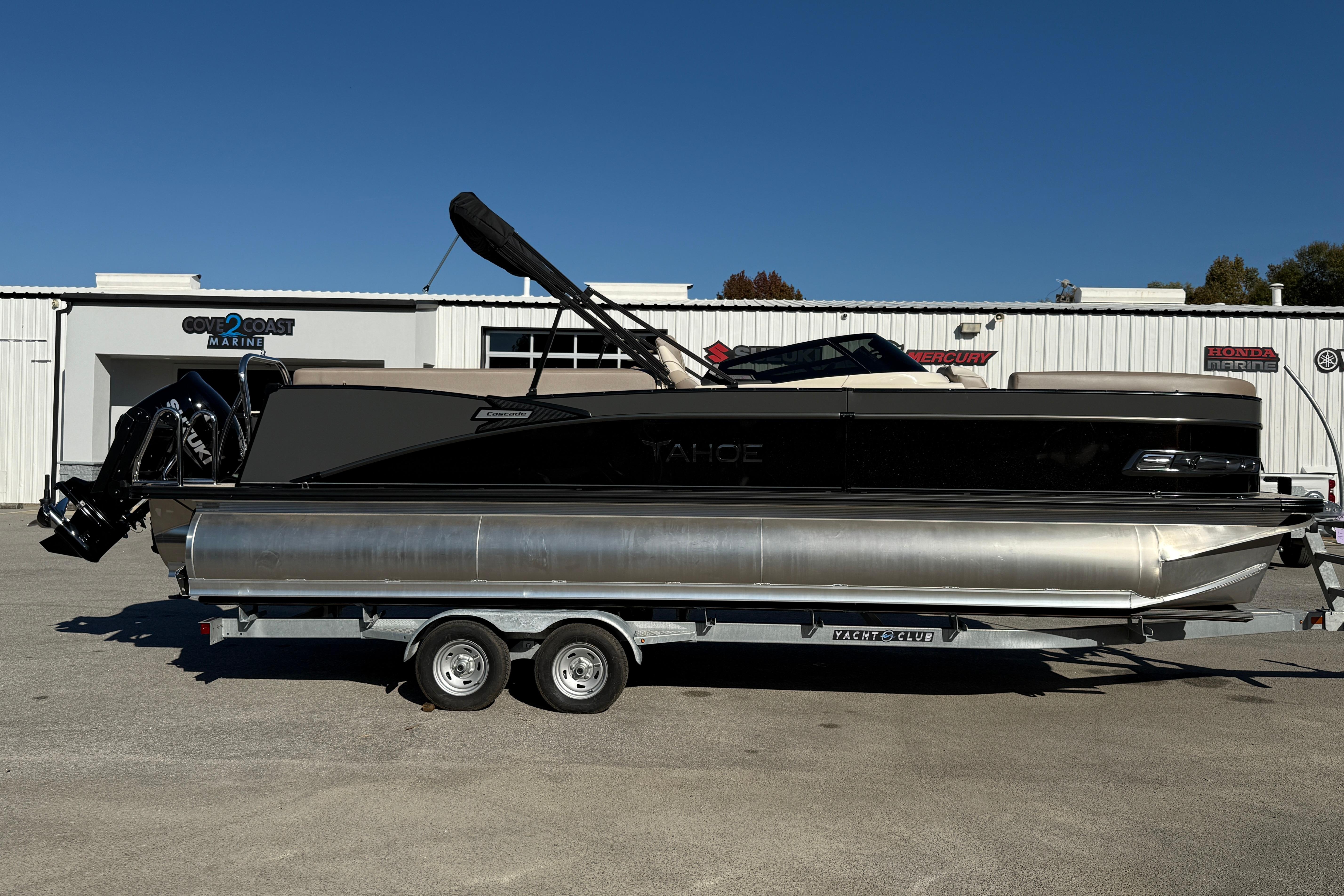 2026 Tahoe Pontoon Cascade Quad Lounger Windshield on trailer, parked outside marine dealership.
