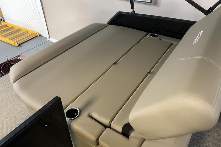 2027 Sylvan Mirage 820 CLZ DH boat interior with beige seating and cup holders.