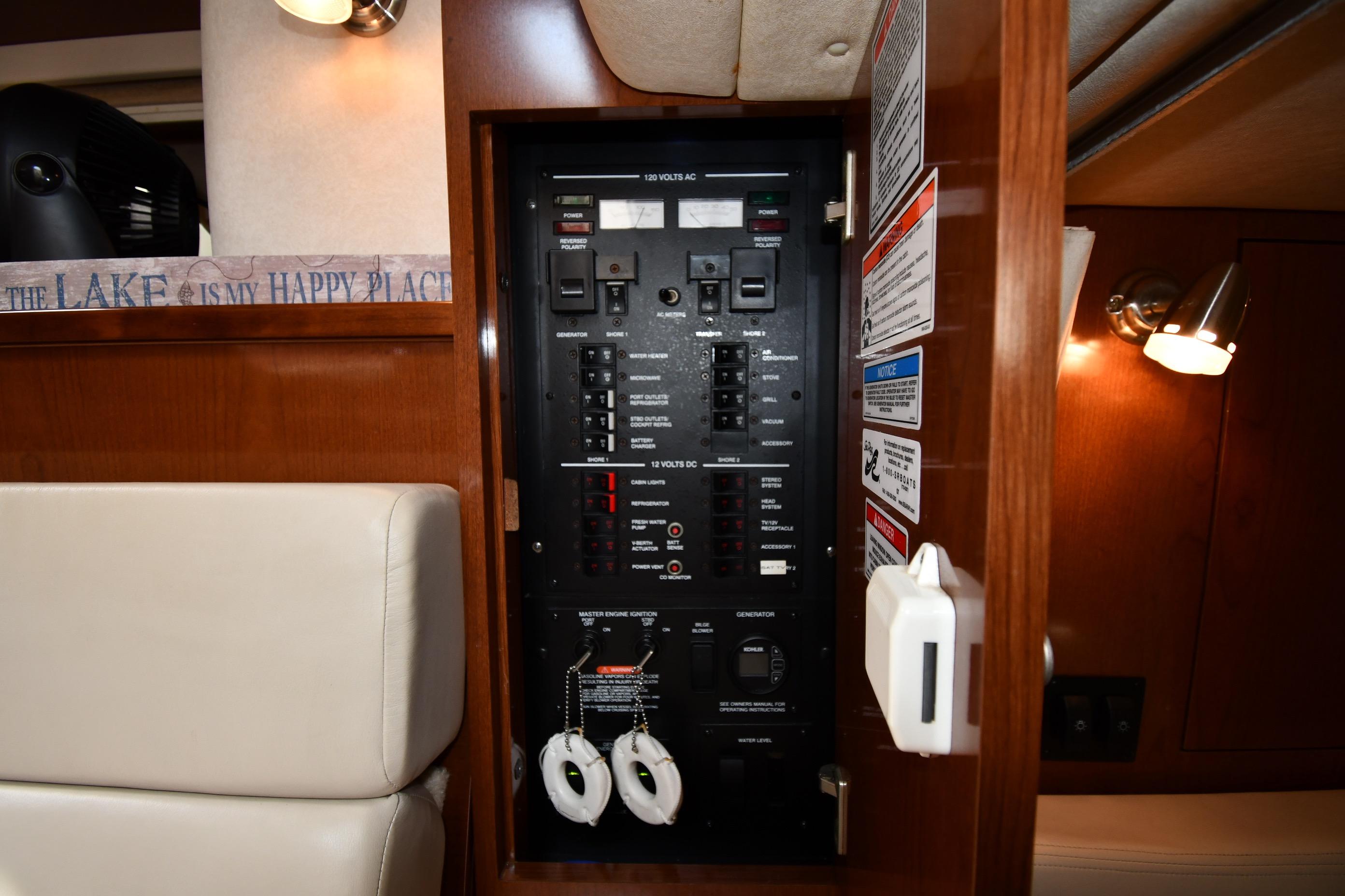 Electrical panel inside 2008 Sea Ray Sundancer 350 yacht cabin, featuring control switches and labels.