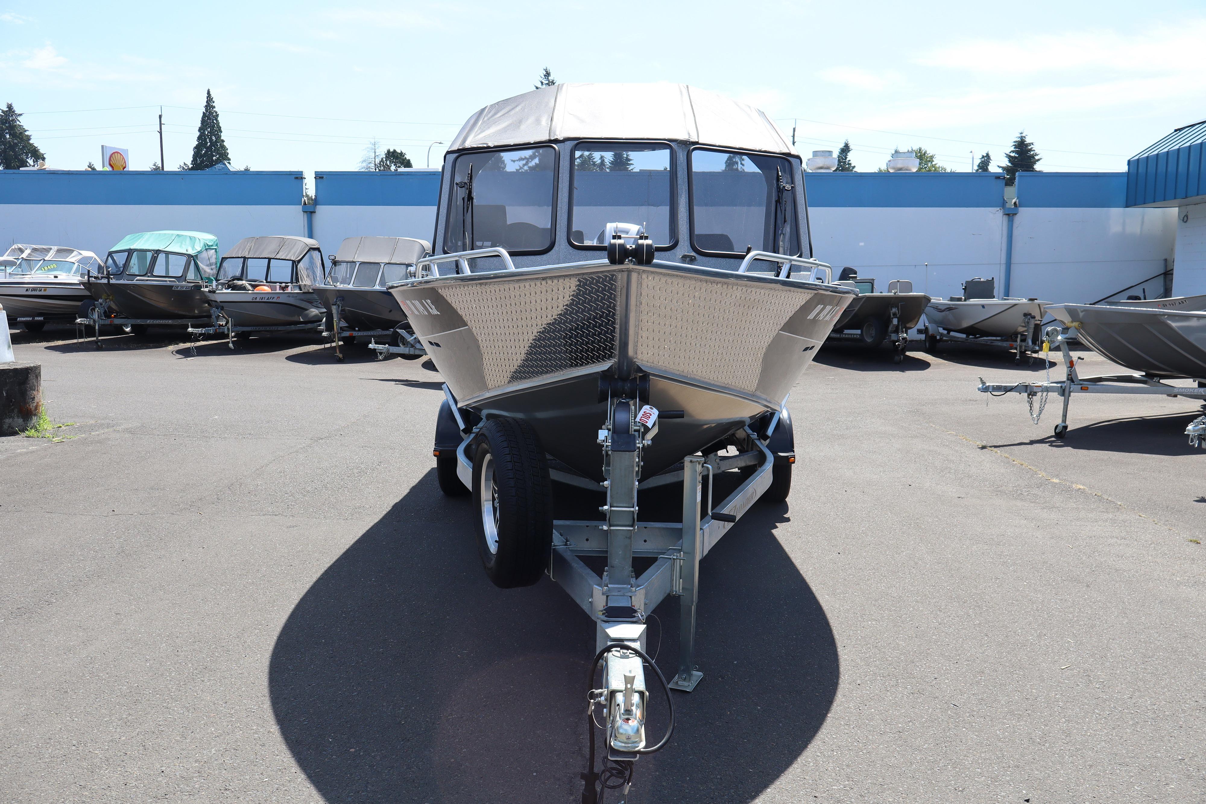 2025 NorthRiver SEAHAWK boat on trailer in outdoor showroom.