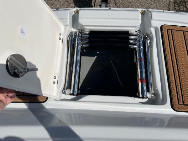 2024 Crownline Eclipse E255 boat ladder compartment with open hatch.