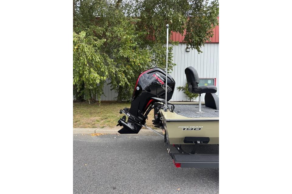 2026 Tracker Pro Team 190 boat with powerful outboard motor, parked outdoors.