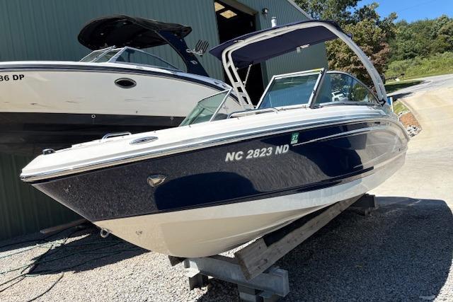 2023 Chaparral 21 SSi boat on display, parked outdoors on a sunny day.