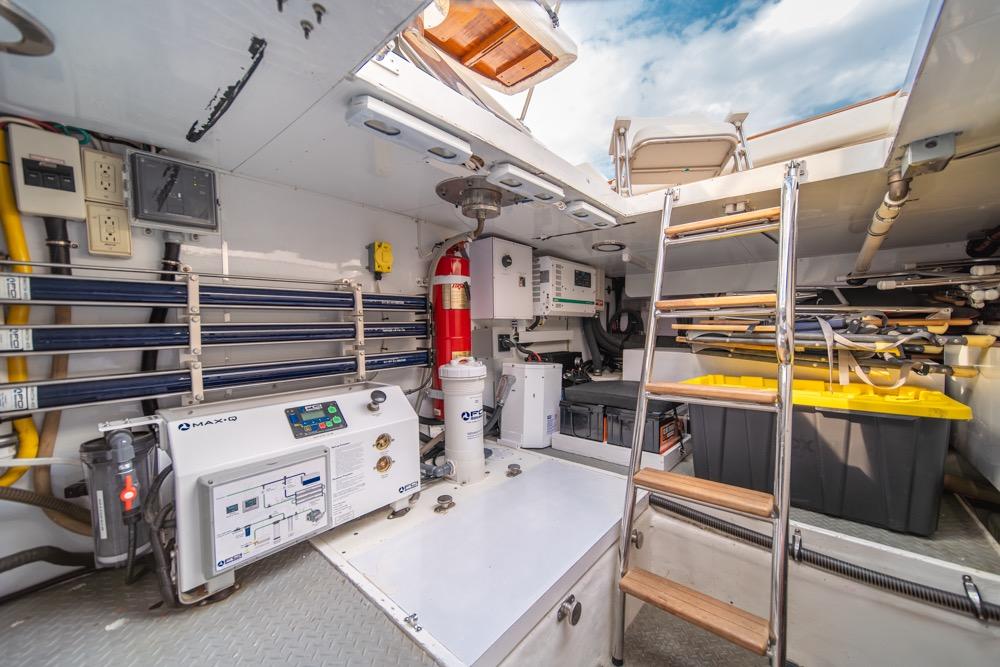 Engine room of 2005 Ocean Alexander 64 Motoryacht with equipment and storage.