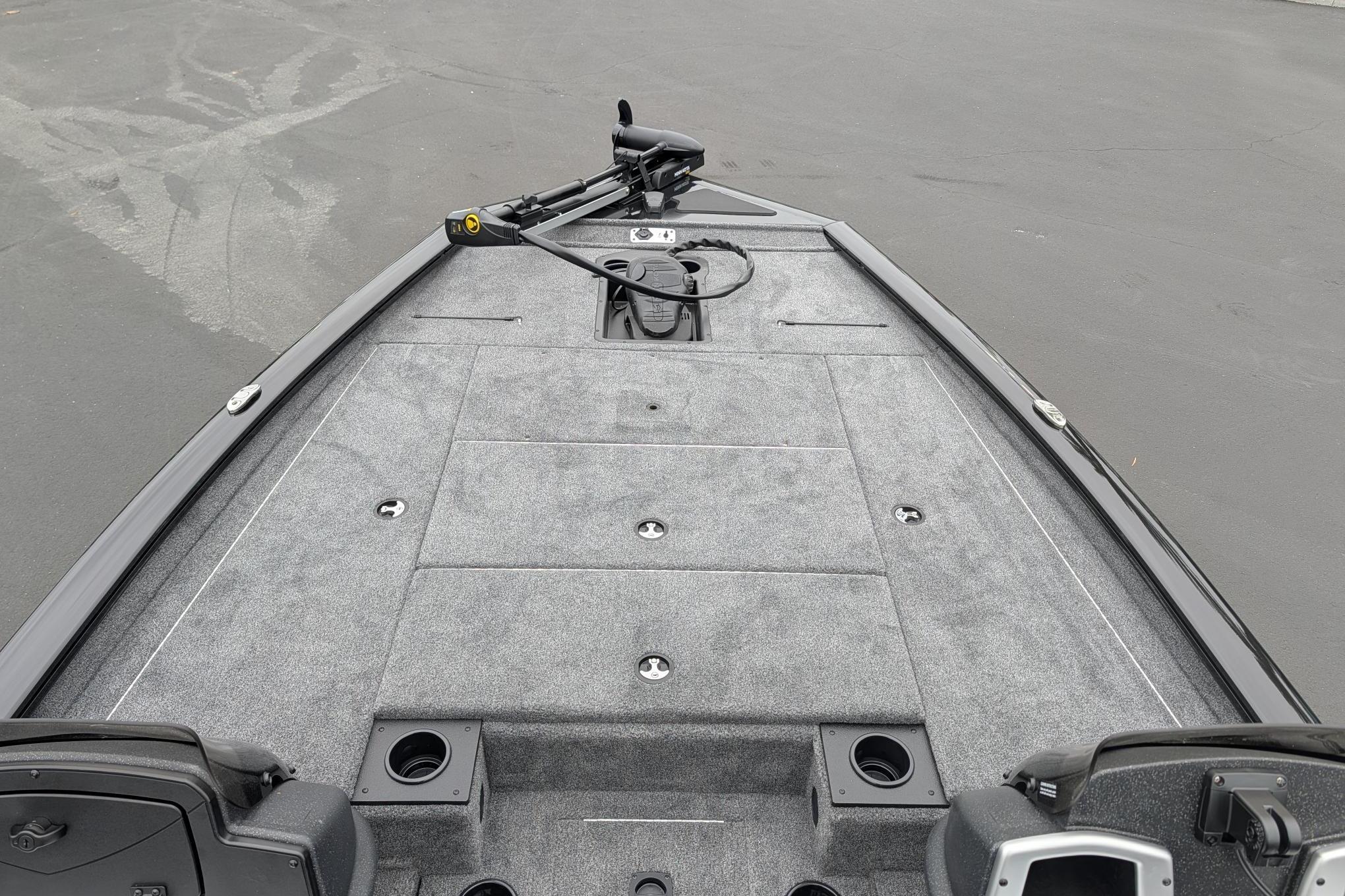 2026 Tracker Pro Team 195 TXW boat deck with gray carpeting and storage compartments.
