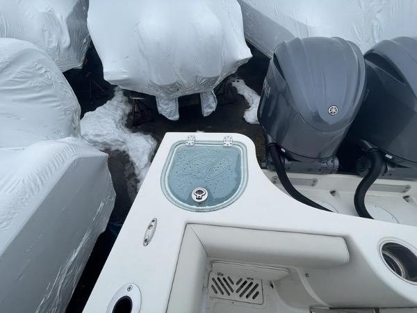 2023 Sailfish 290 CC boat with dual engines, surrounded by covered boats.