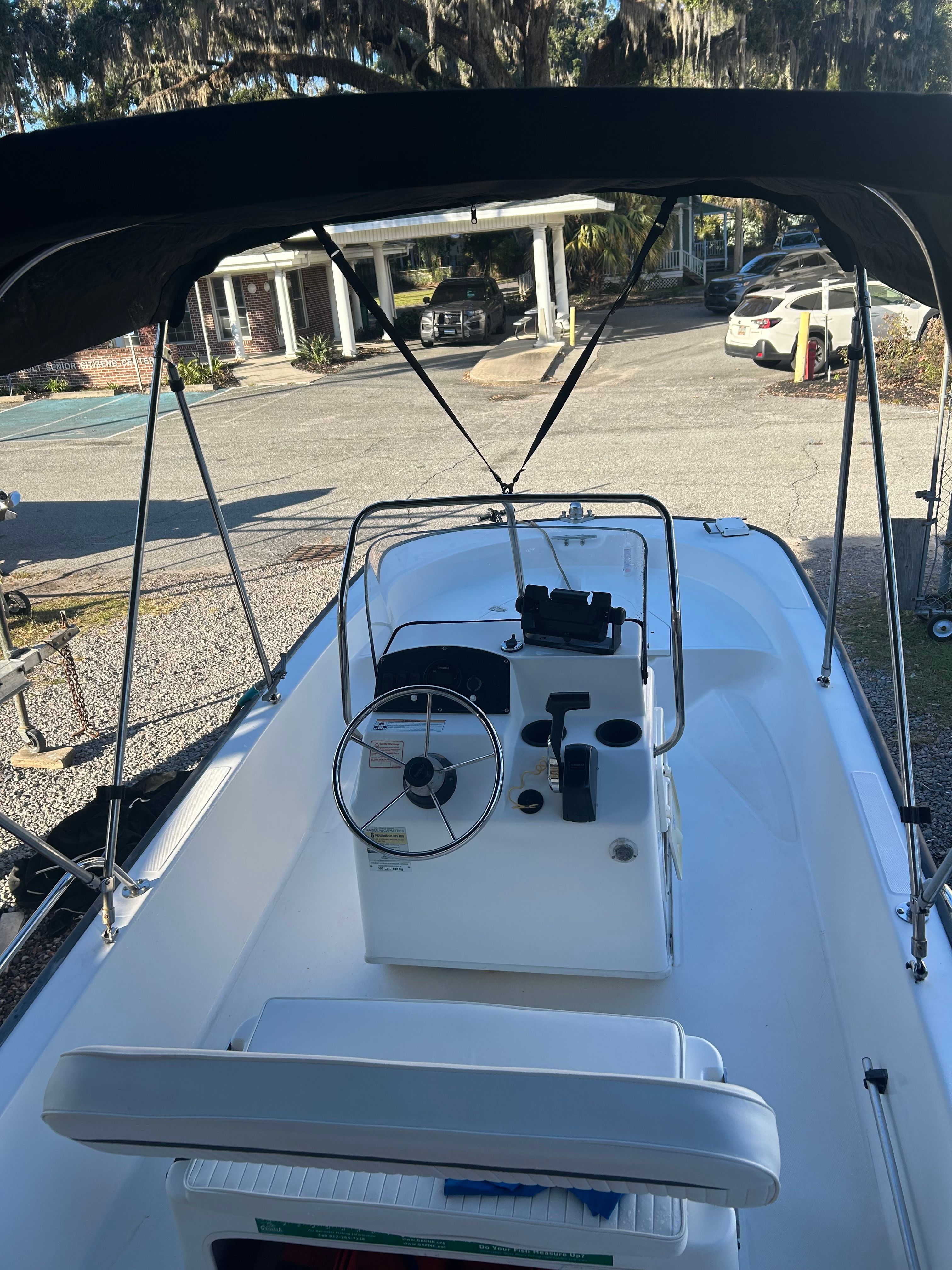 2006 Boston Whaler 150 Montauk boat with helm and Bimini top.