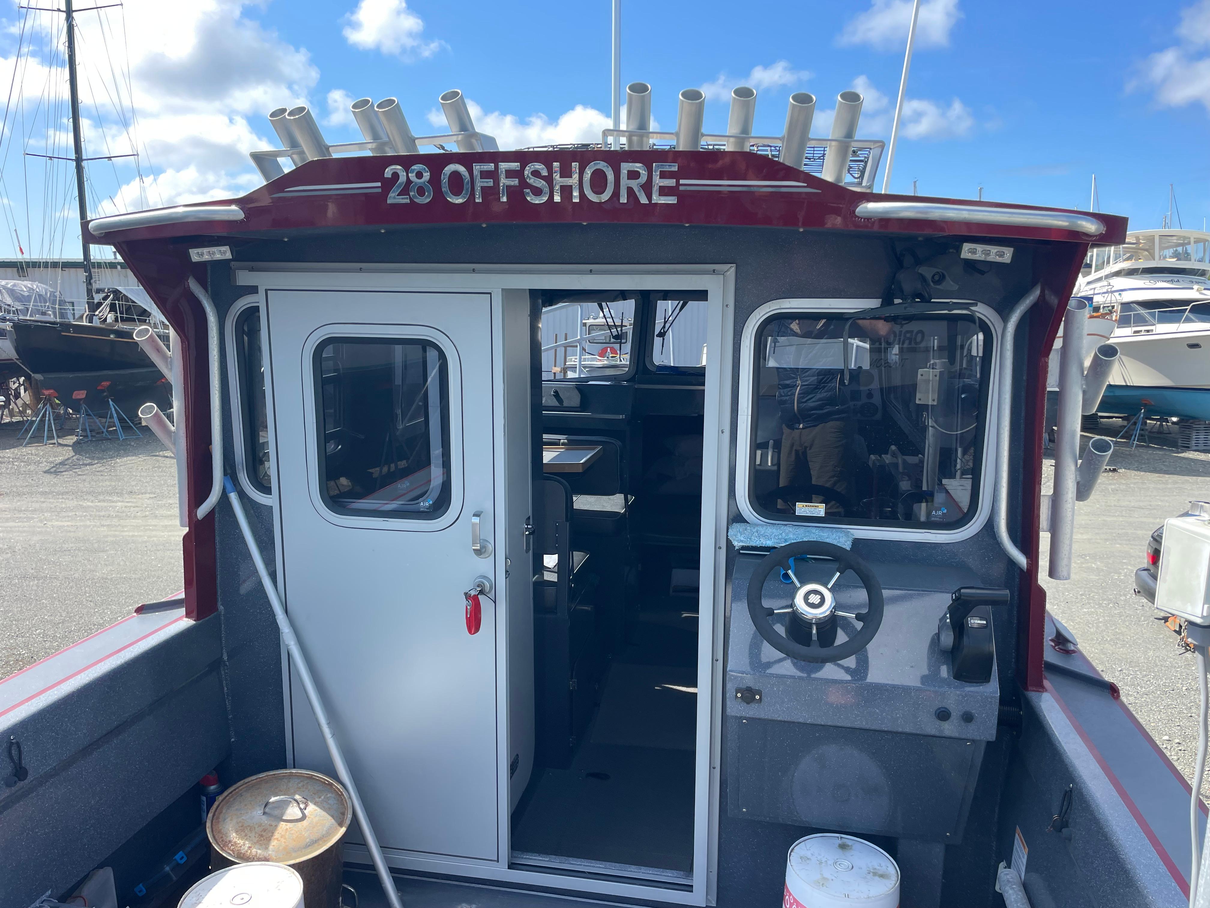 2018 Duckworth 28 Offshore boat with cabin, docked under a clear blue sky.