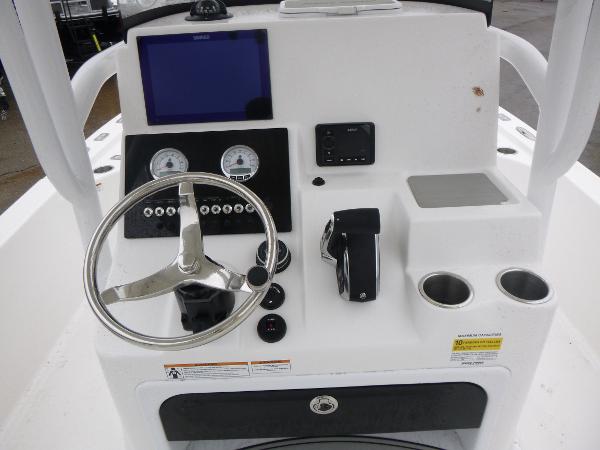 2025 Sea Pro 250 Bay boat console with steering wheel, gauges, and cup holders.