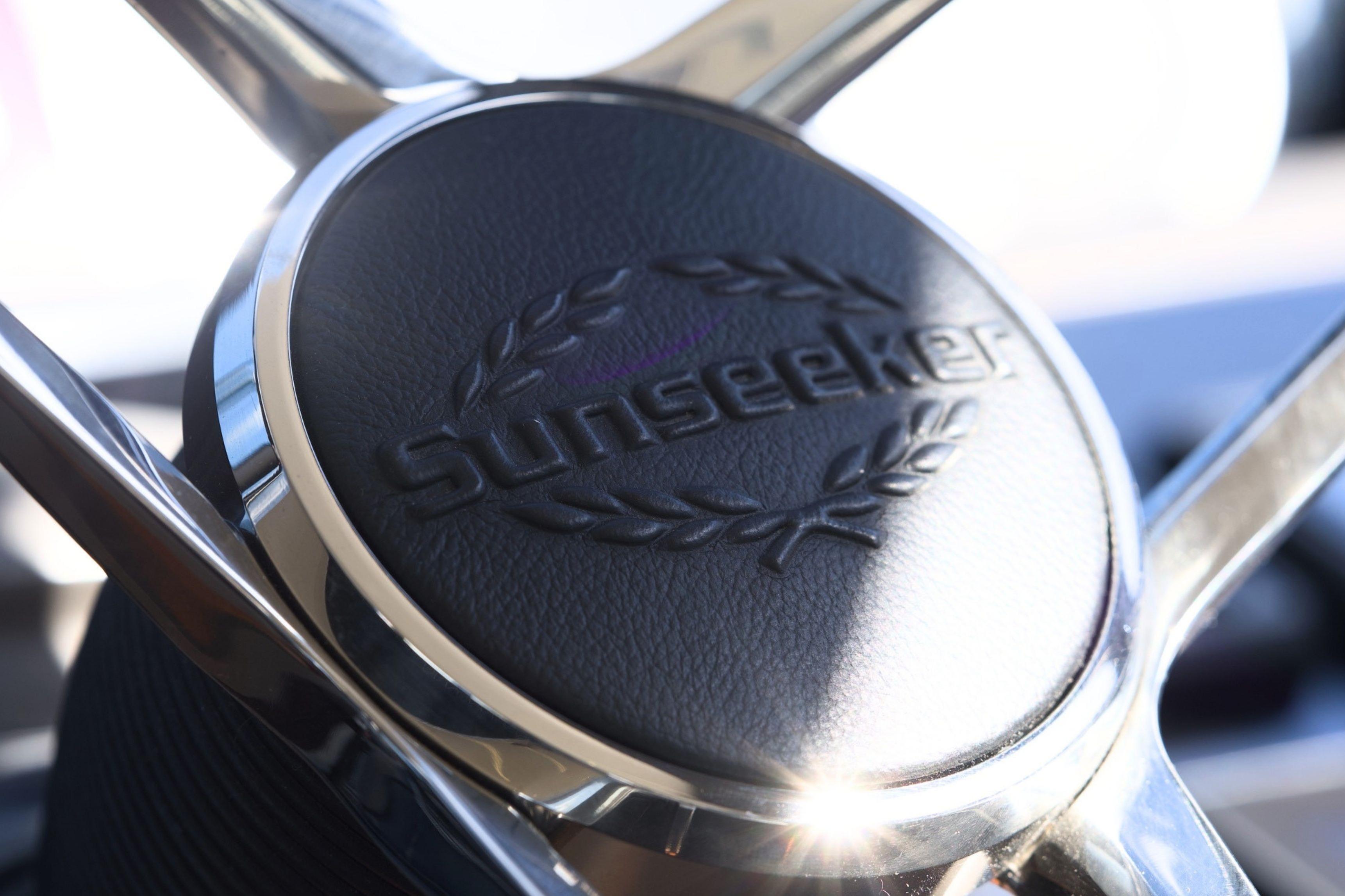 Steering wheel of 2019 Sunseeker Manhattan 52 yacht, featuring embossed logo.