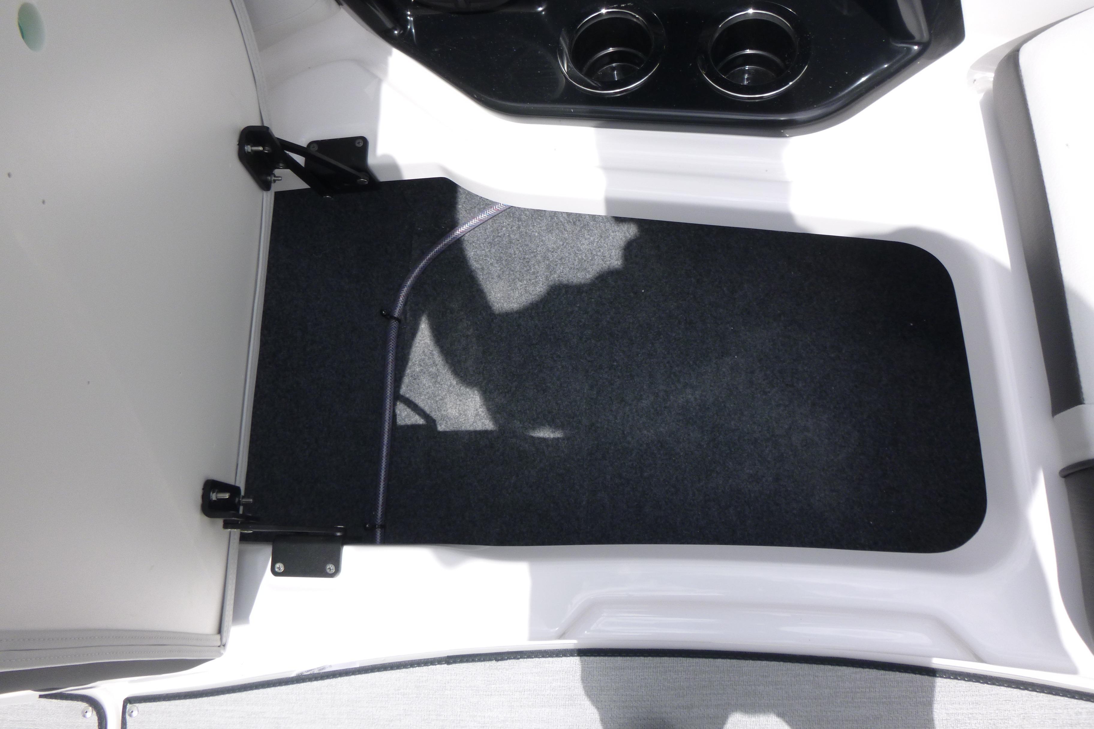 Interior view of 2026 Yamaha AR250 boat with cup holders and carpeted flooring.
