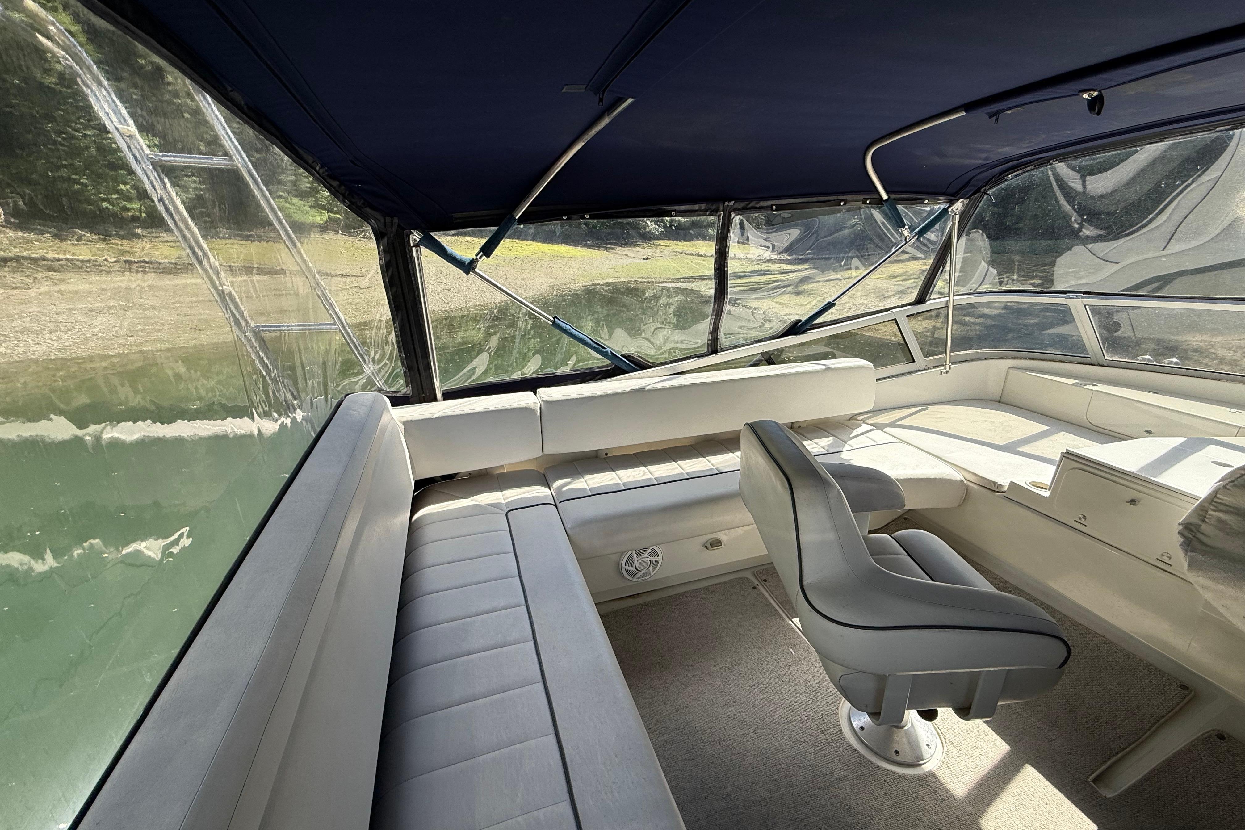 Interior view of a 1995 Carver 370 Voyager boat with seating and helm.