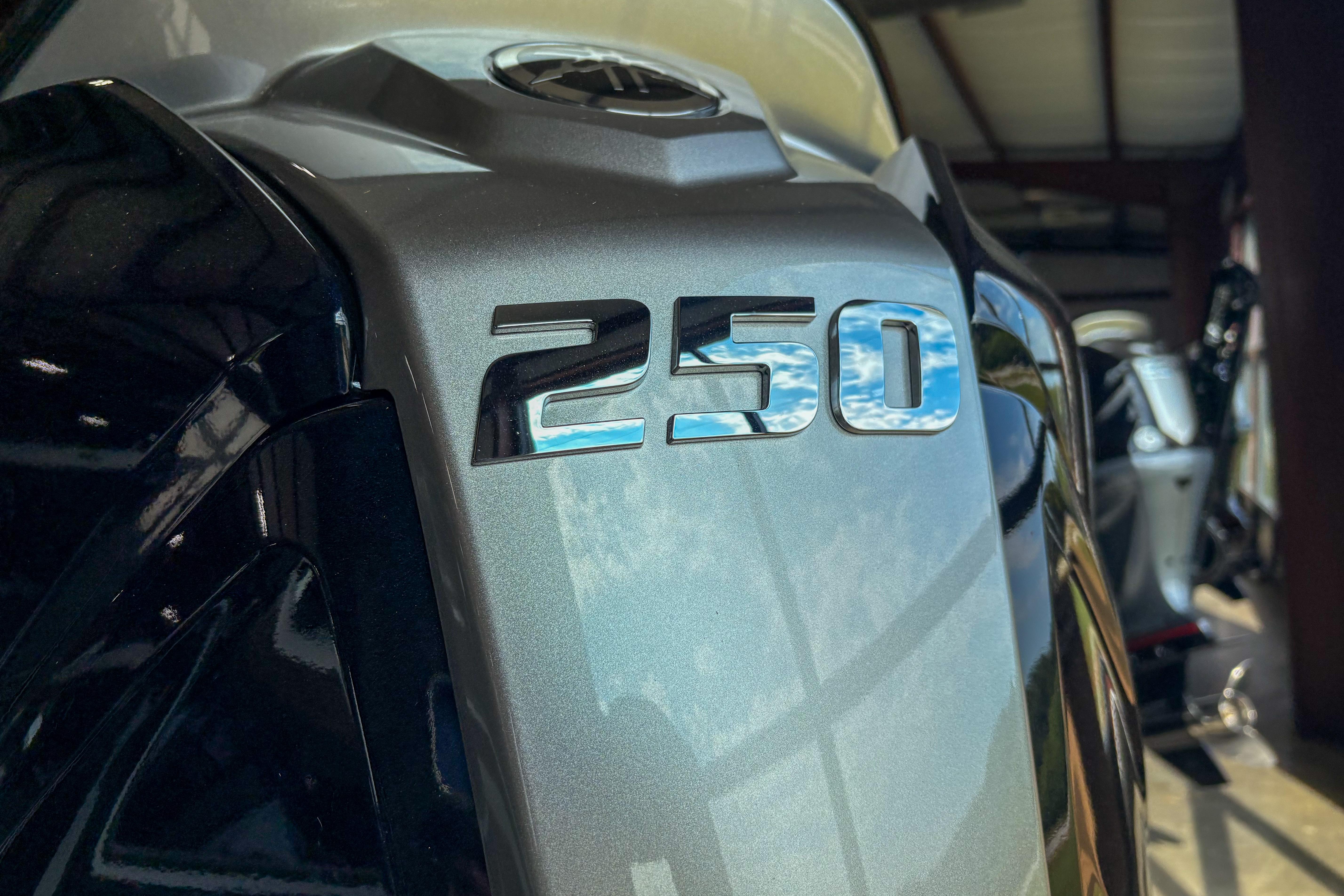 Close-up of 2026 Skeeter ZXE20 with "250" emblem, reflecting sky.