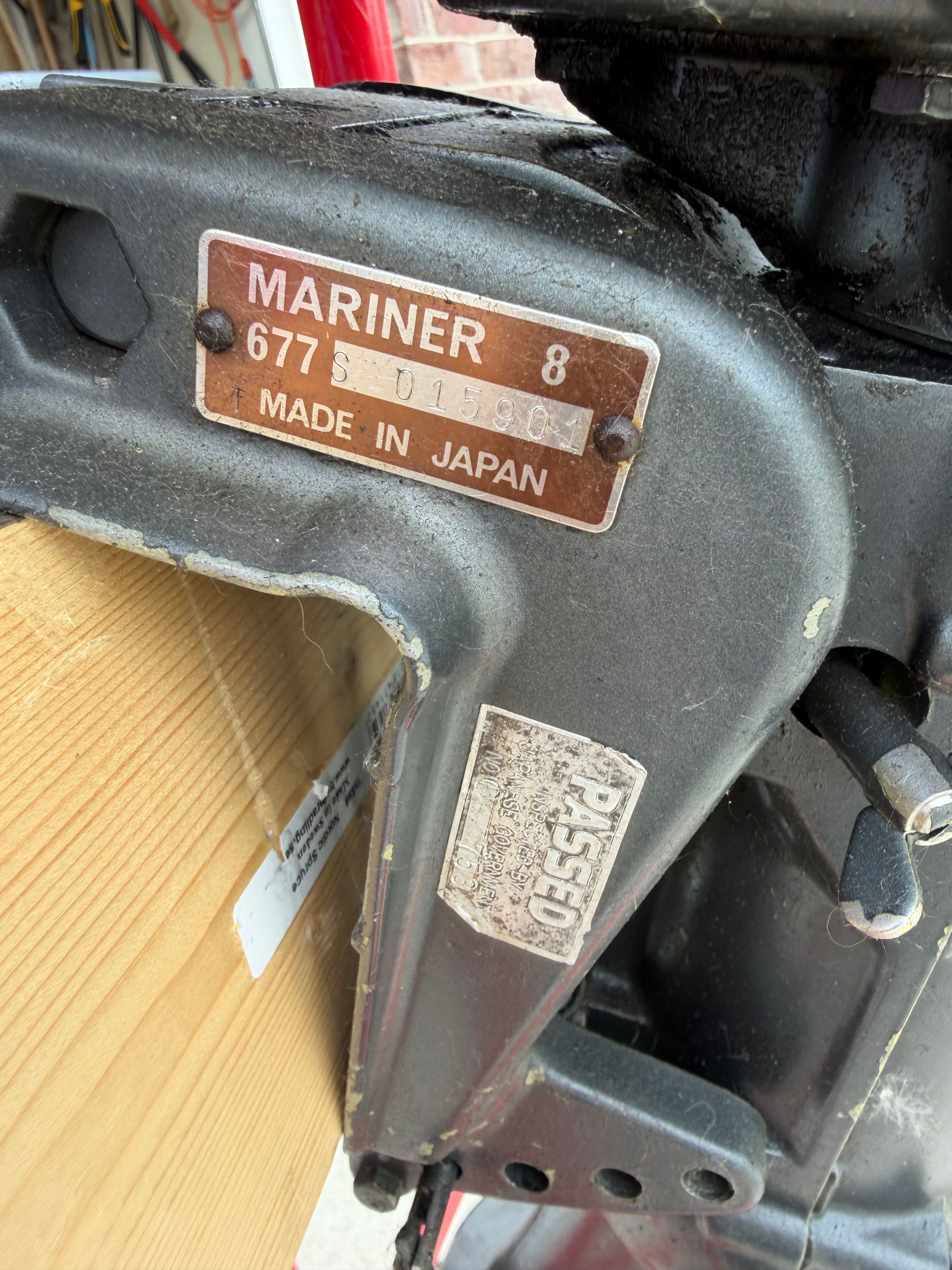 Close-up of an outboard motor with a "Mariner 8" and "Made in Japan" label.