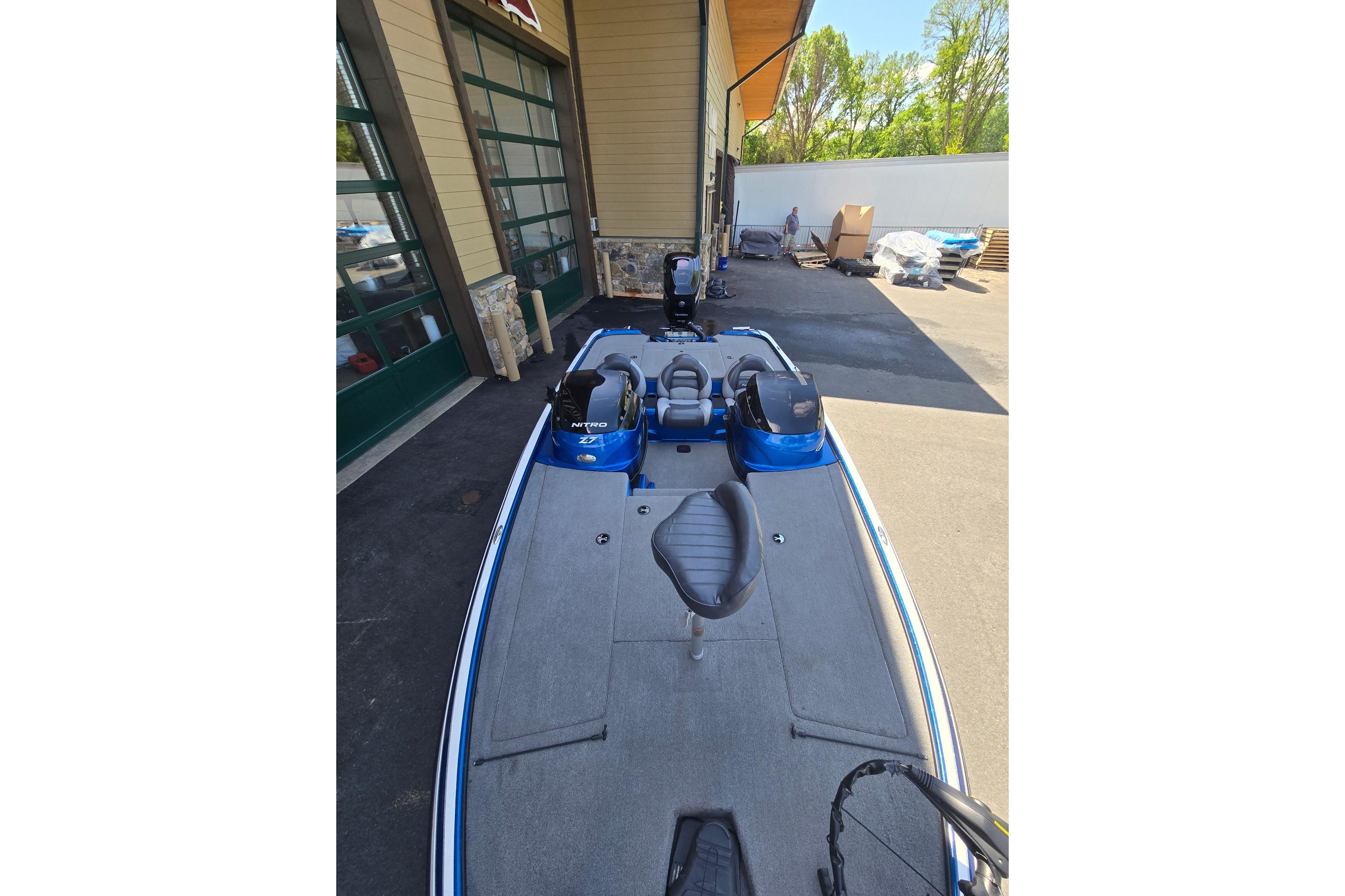 2014 Nitro Z-7 boat parked outside a building, featuring a sleek blue design.
