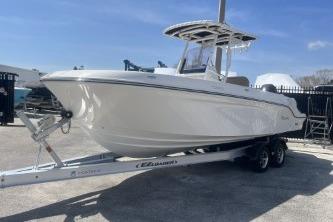 2023 Trophy T24 CC boat on trailer under clear blue sky.