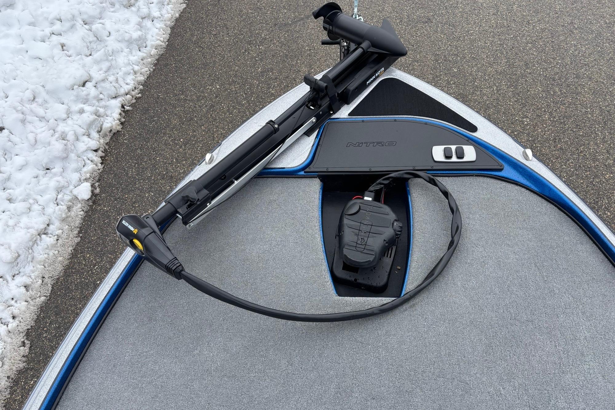 Bow of 2026 Nitro Z17 boat with trolling motor and snow nearby.