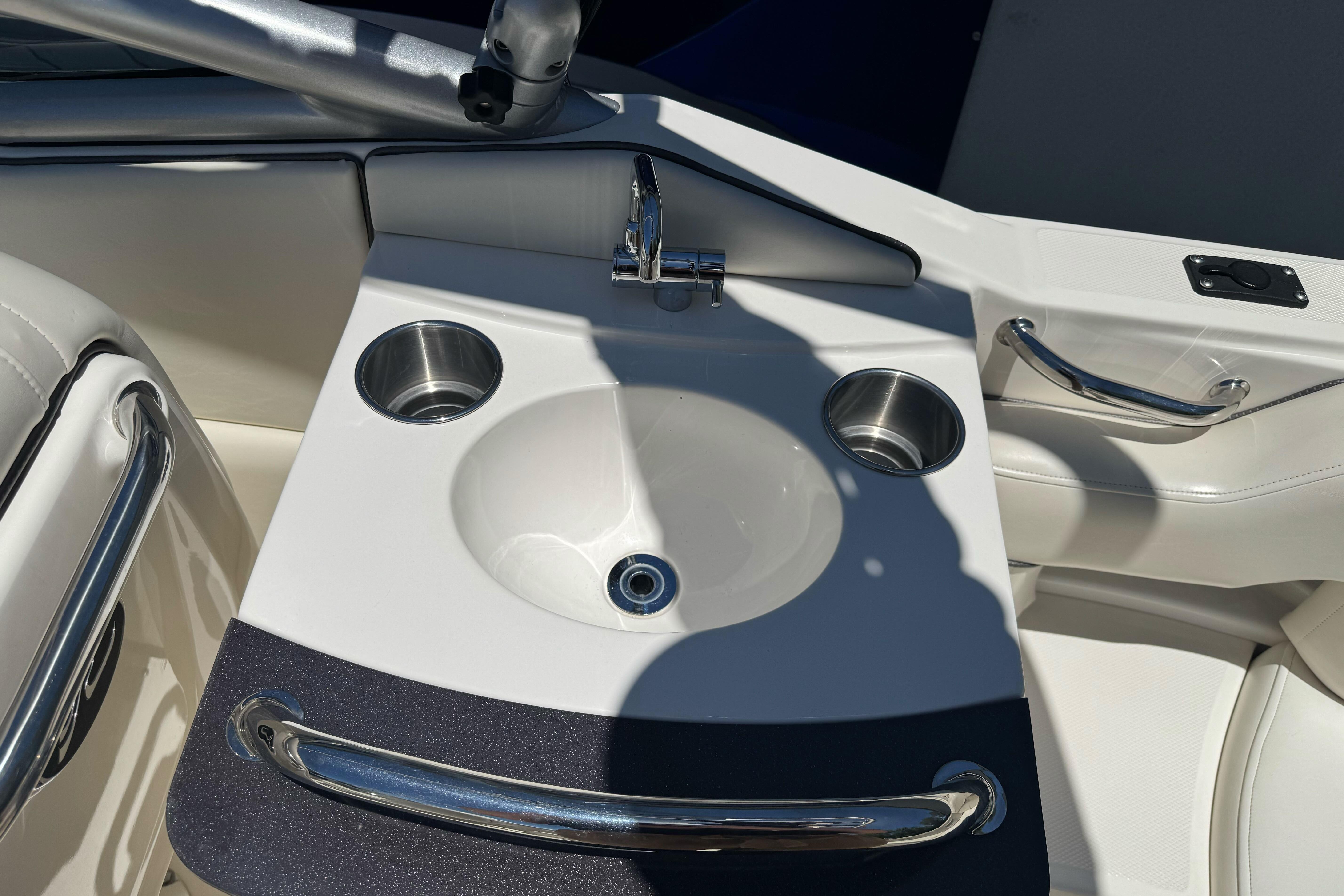 2007 Sea Ray SLX 250 boat sink with stainless steel cup holders and faucet.
