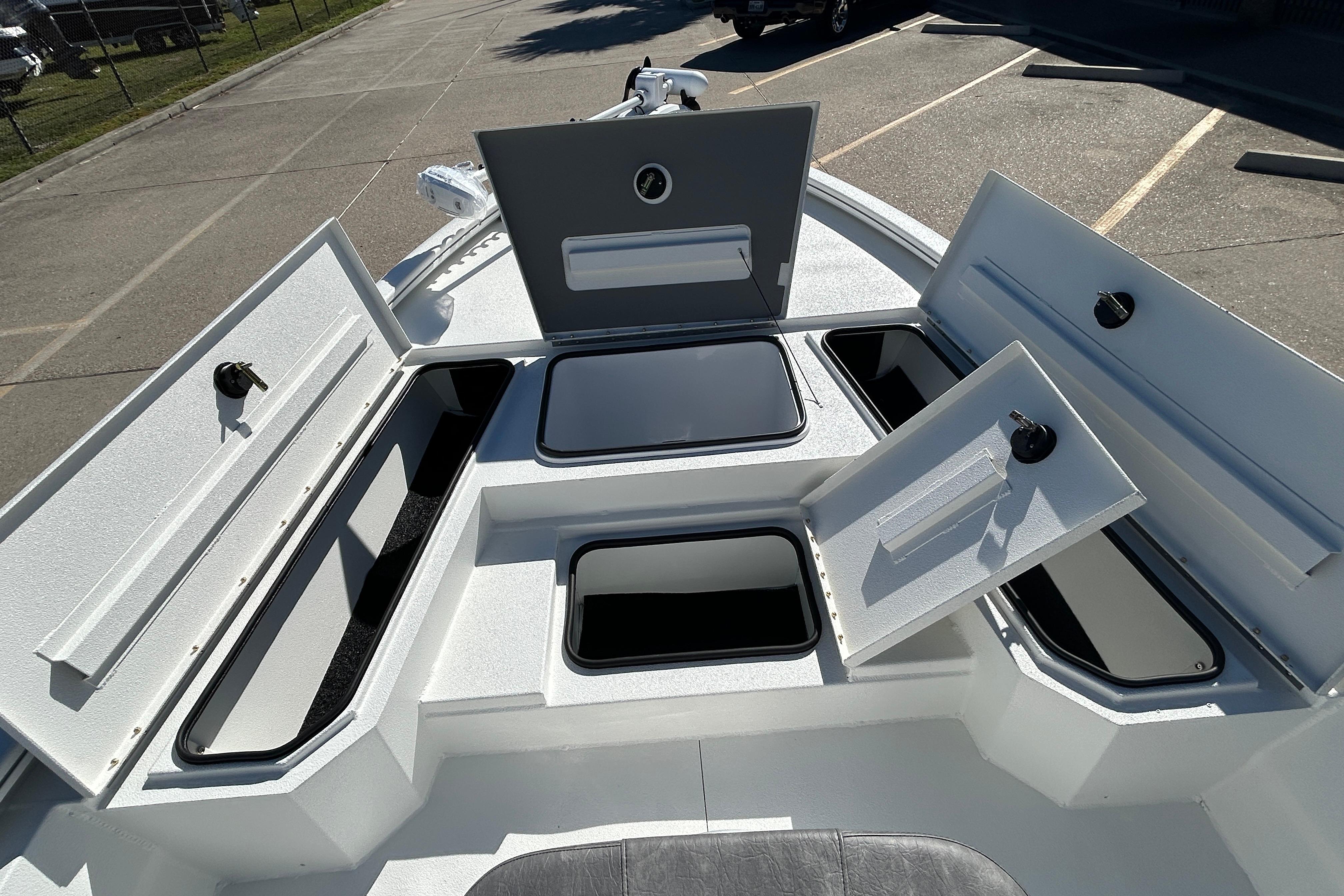 2025 Avid 21 FST boat with open storage compartments on deck.