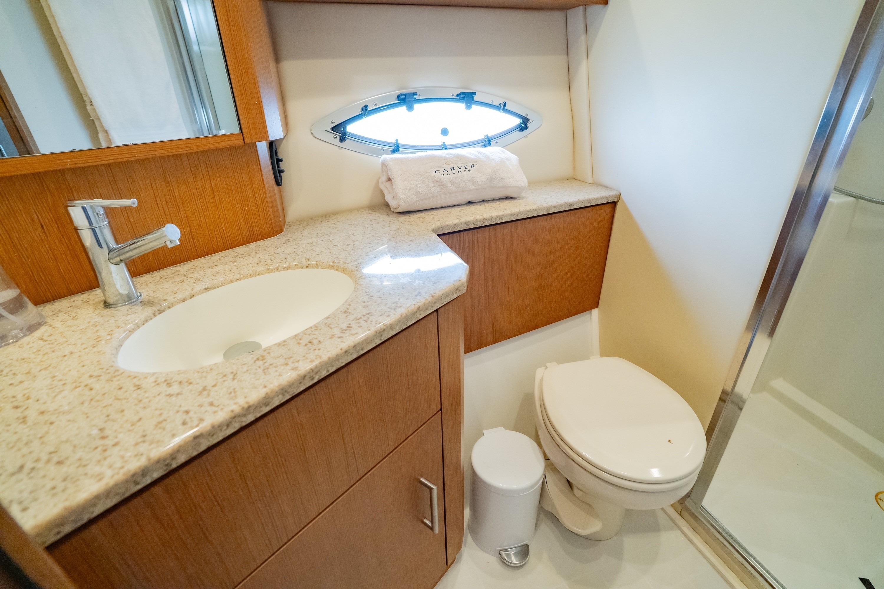 Luxurious bathroom in 2011 Carver 44 Sojourn yacht with modern fixtures and elegant design.