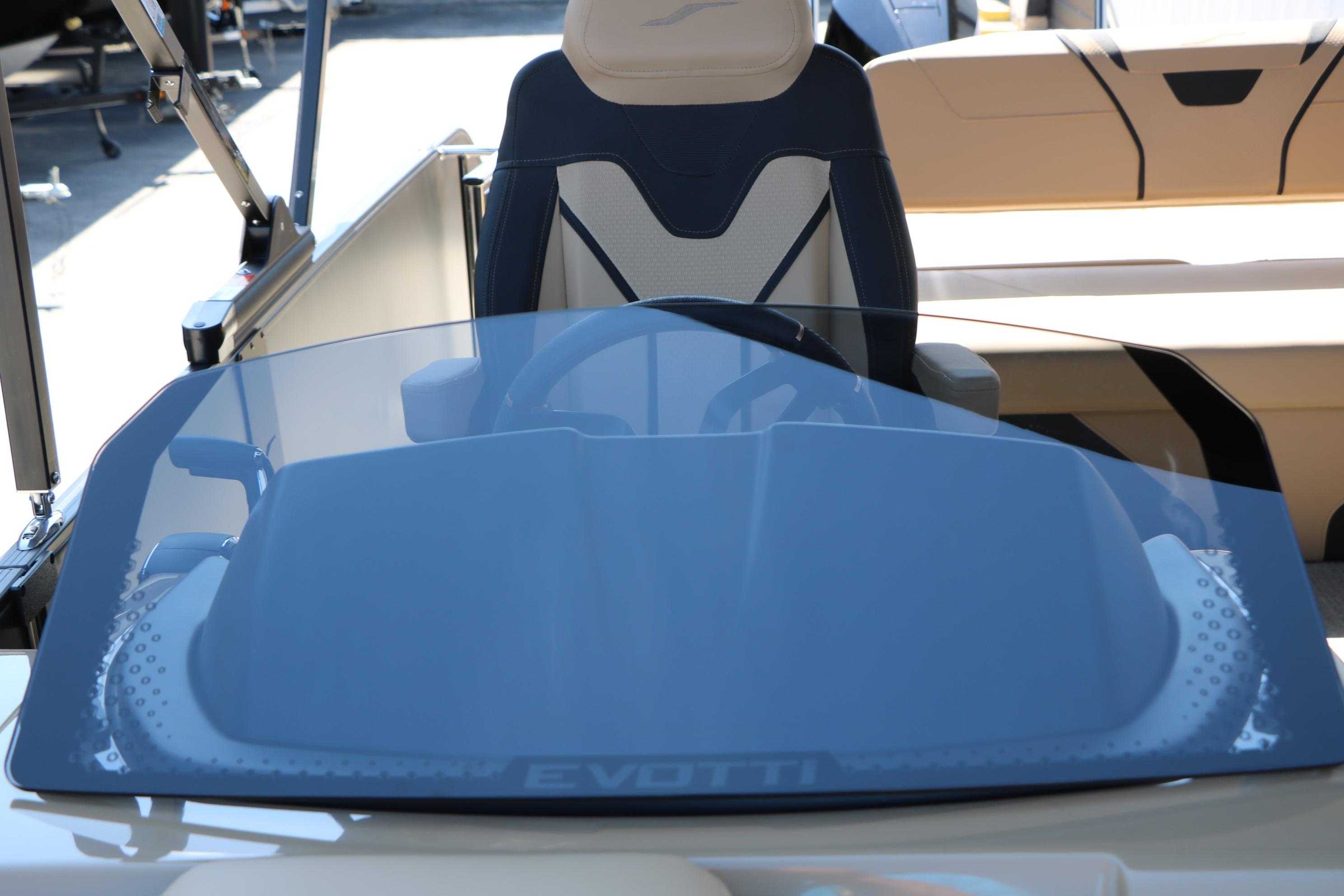 2026 Evotti 725 CS Tri-Toon boat cockpit with steering wheel and seating.