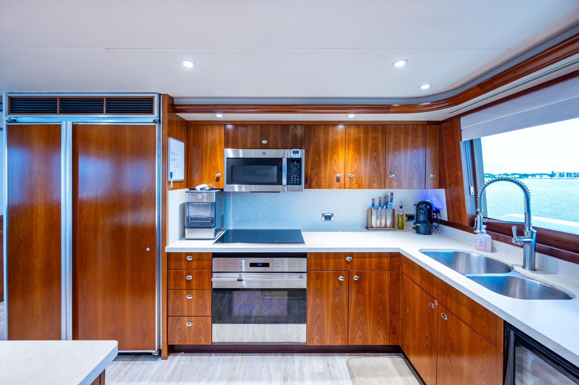 Luxurious kitchen interior on 2006 Westport w112 yacht with modern appliances and ocean view.