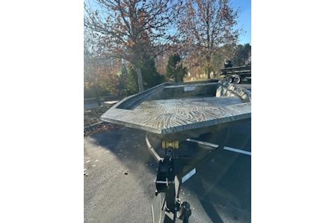 2025 Tracker Grizzly 1860 Utility boat on trailer, parked outdoors on a sunny day.
