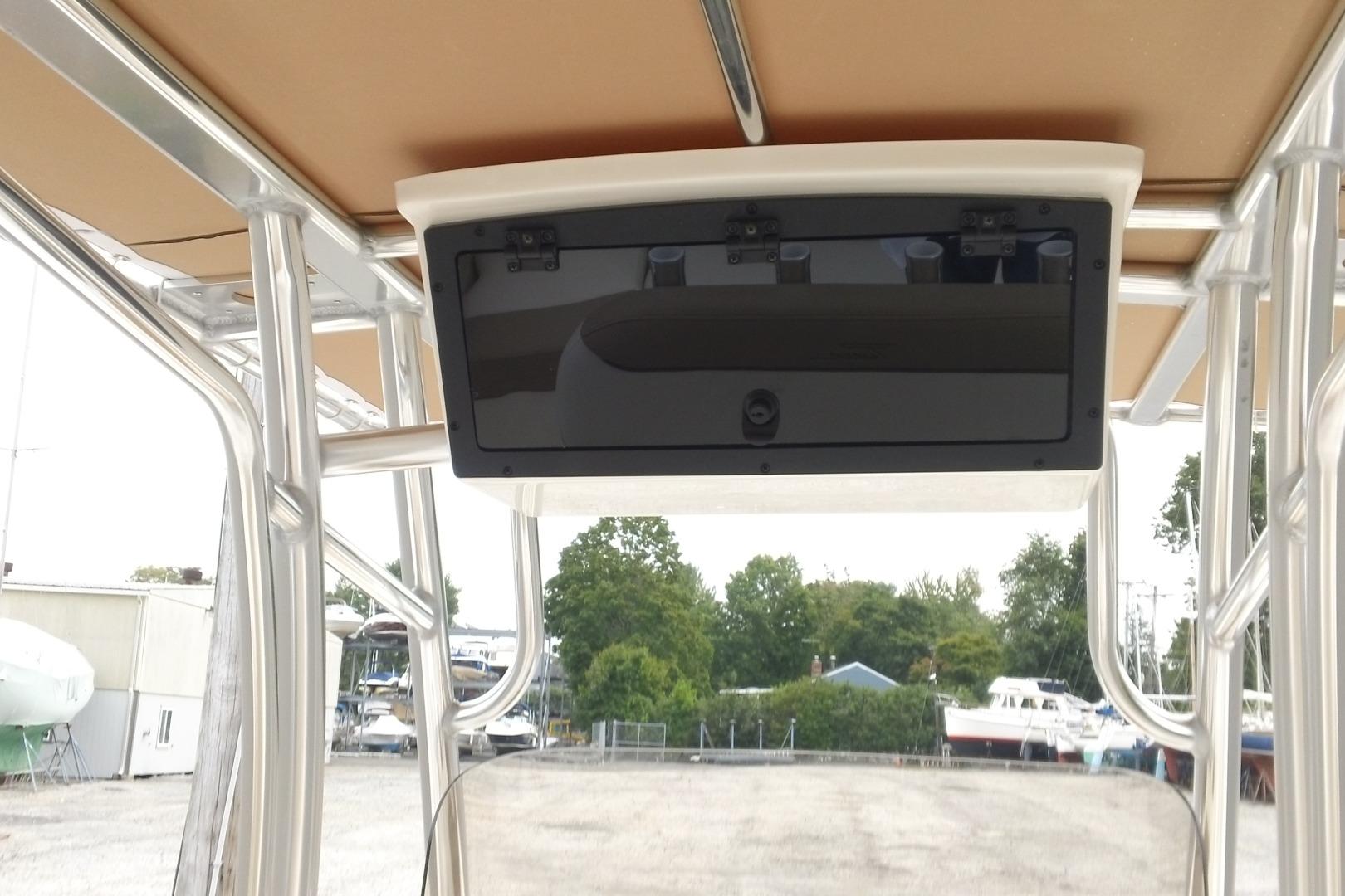 2026 Pioneer 202 Islander boat console with storage compartment, docked outdoors.